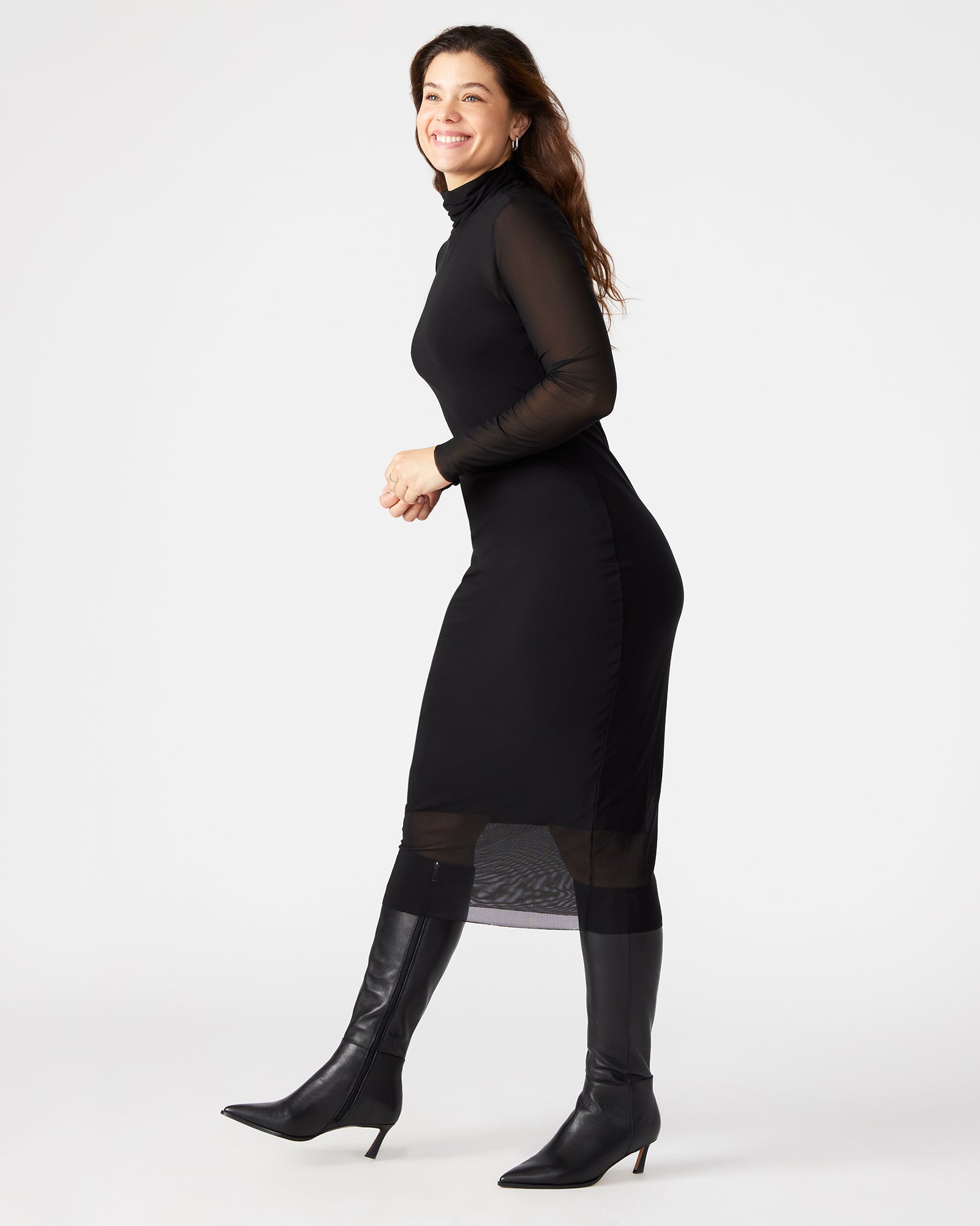 Model pairing the VIVIENNE black dress with elegant accessories for a wedding guest look