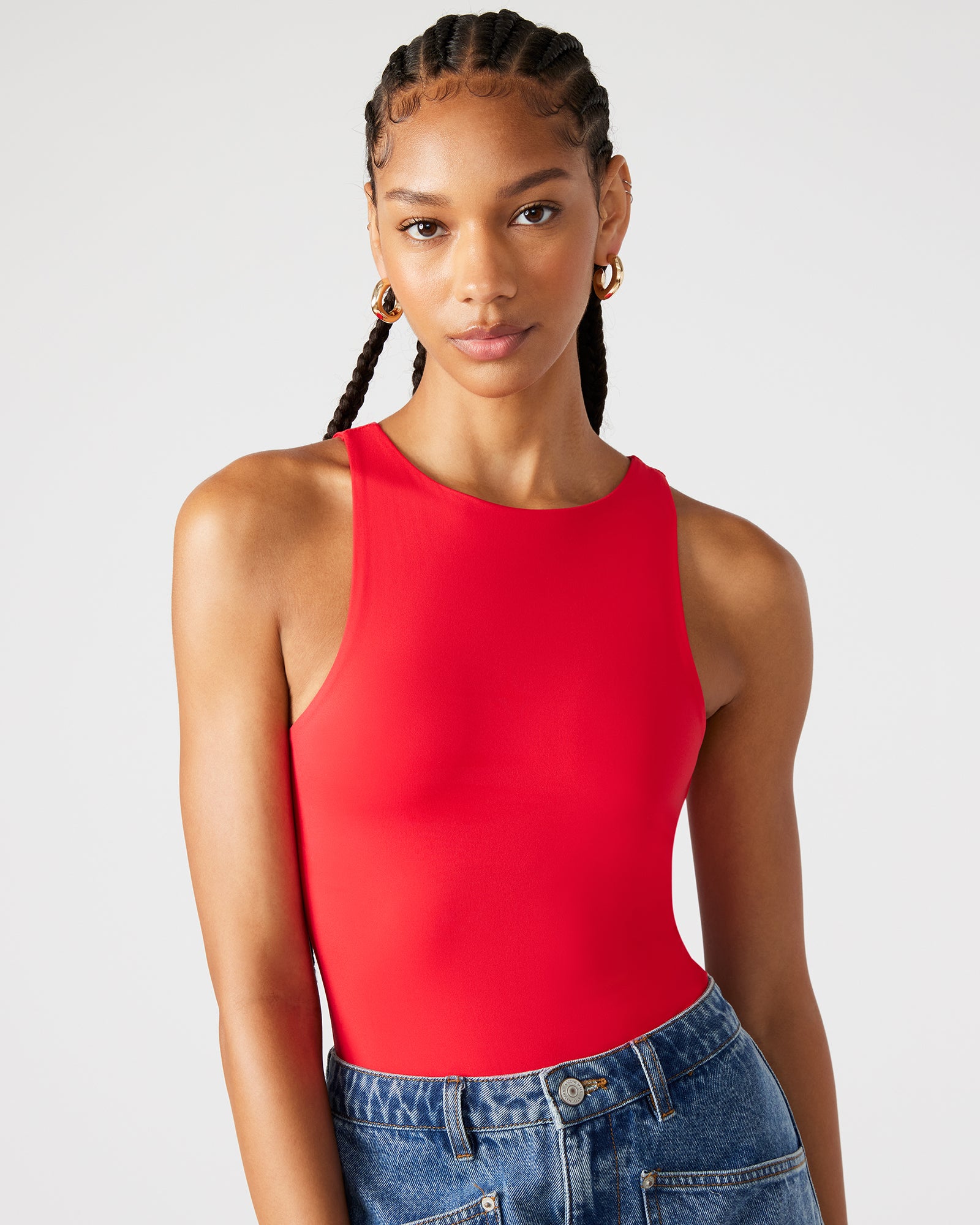 Flat lay of crew neck bodysuit showing bottom snap closure and bust lining detail