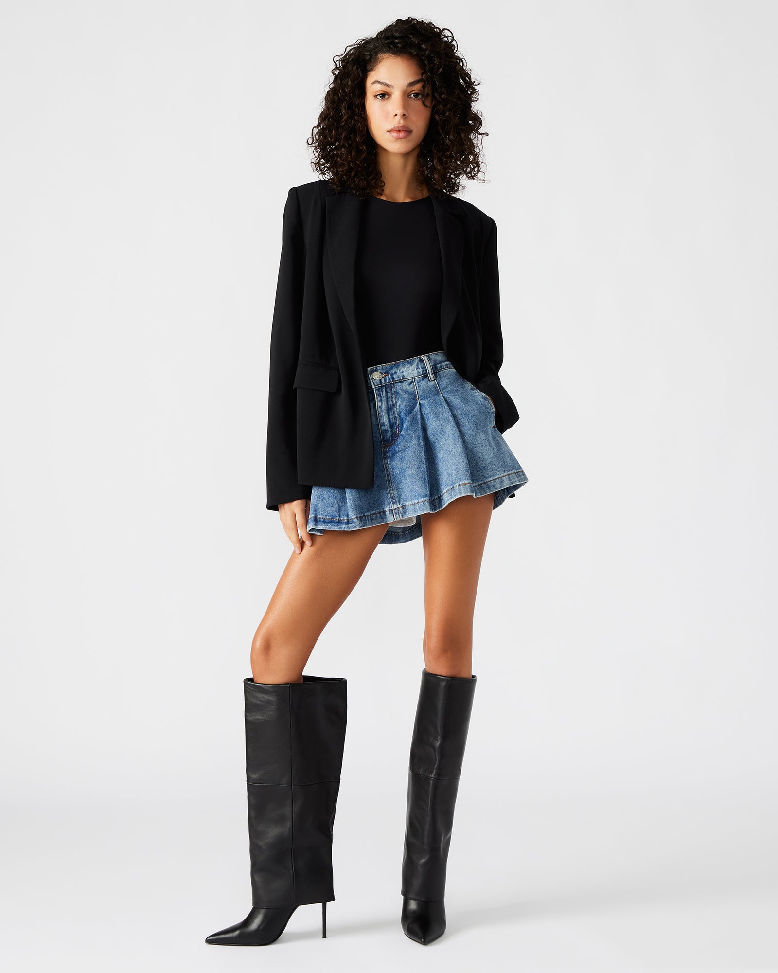 Side view of the Payton blazer worn casually over a dress.