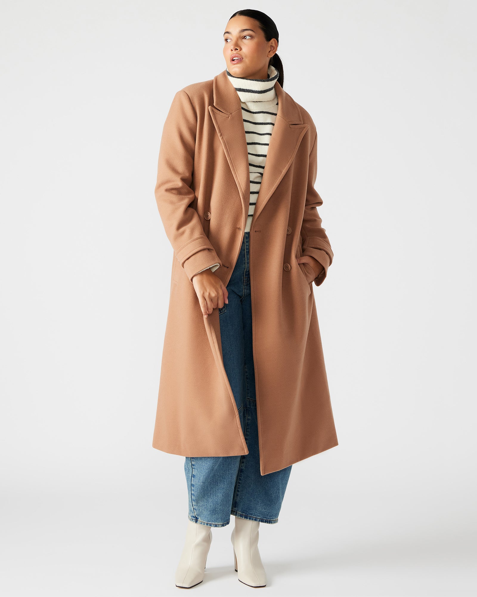Side view of the camel hair coat, highlighting the structured silhouette and shoulder pads.