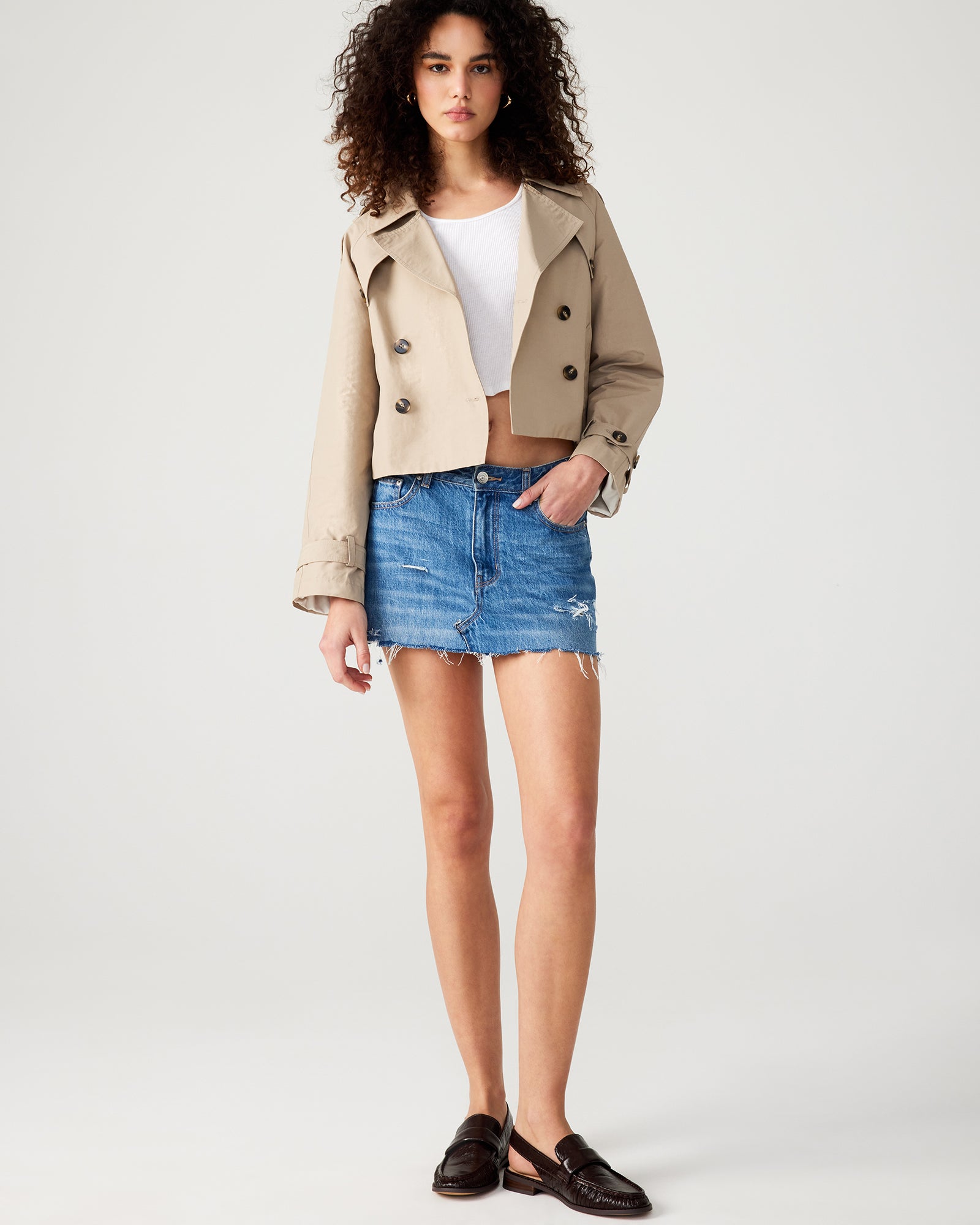 Back view highlighting pleated flap and shoulder epaulettes of the cropped jacket.
