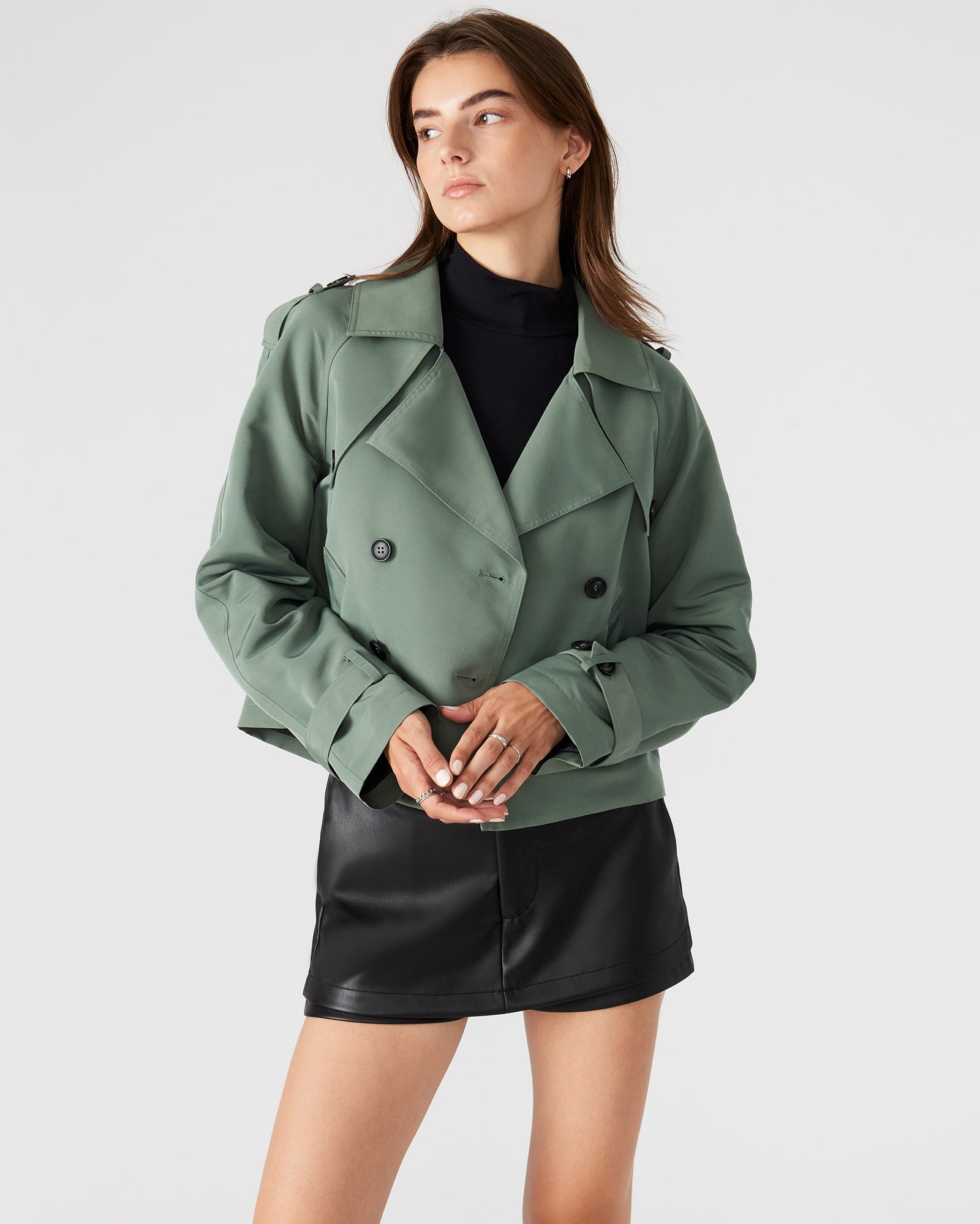 Front view of the SIRUS cropped trench coat in light green, showcasing its double-breasted design.