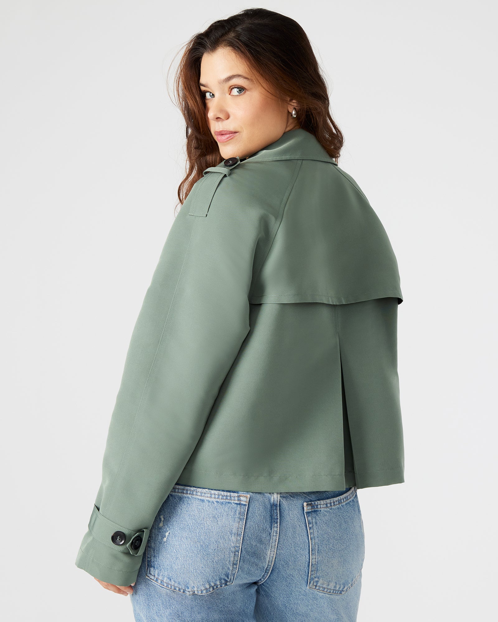 Front view of the SIRUS cropped trench coat in light green, showcasing its double-breasted design.