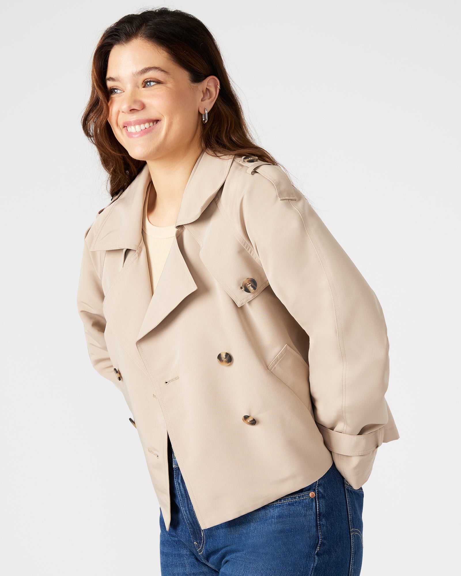 Back view highlighting pleated flap and shoulder epaulettes of the cropped jacket.