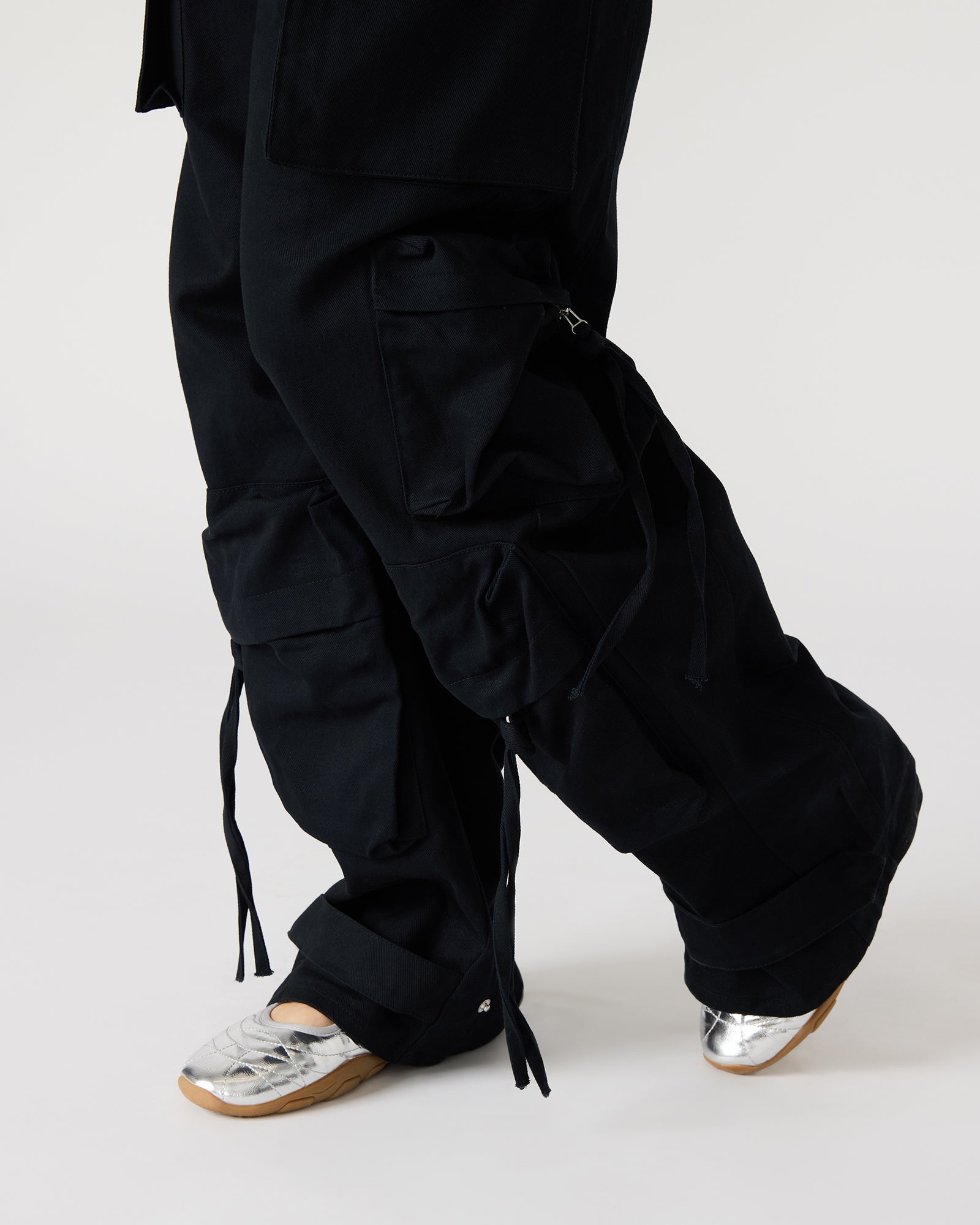 Close-up of the snap strap detail on the ankle of the pants