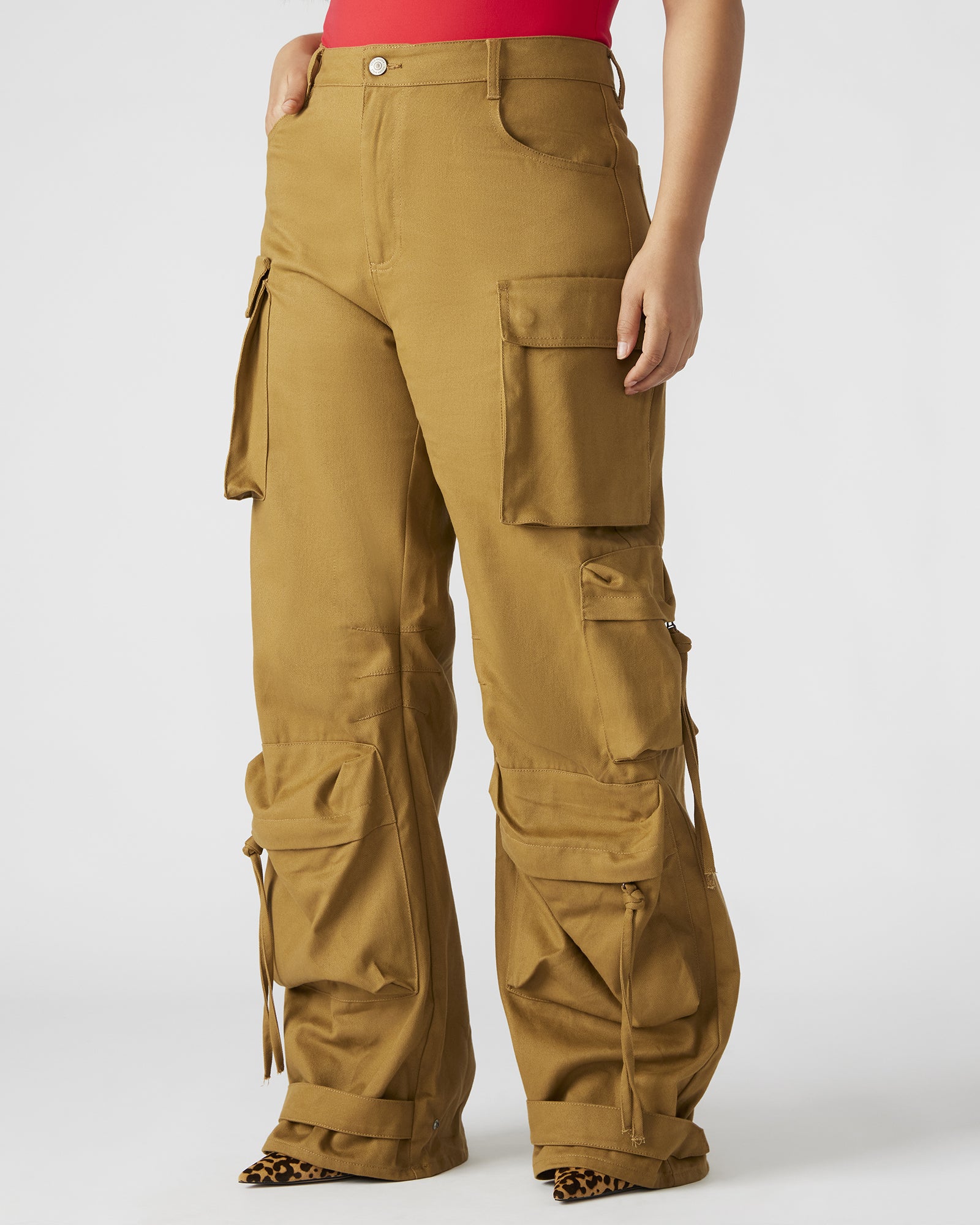 Front view of versatile khaki cargo pants with adjustable ankle straps.