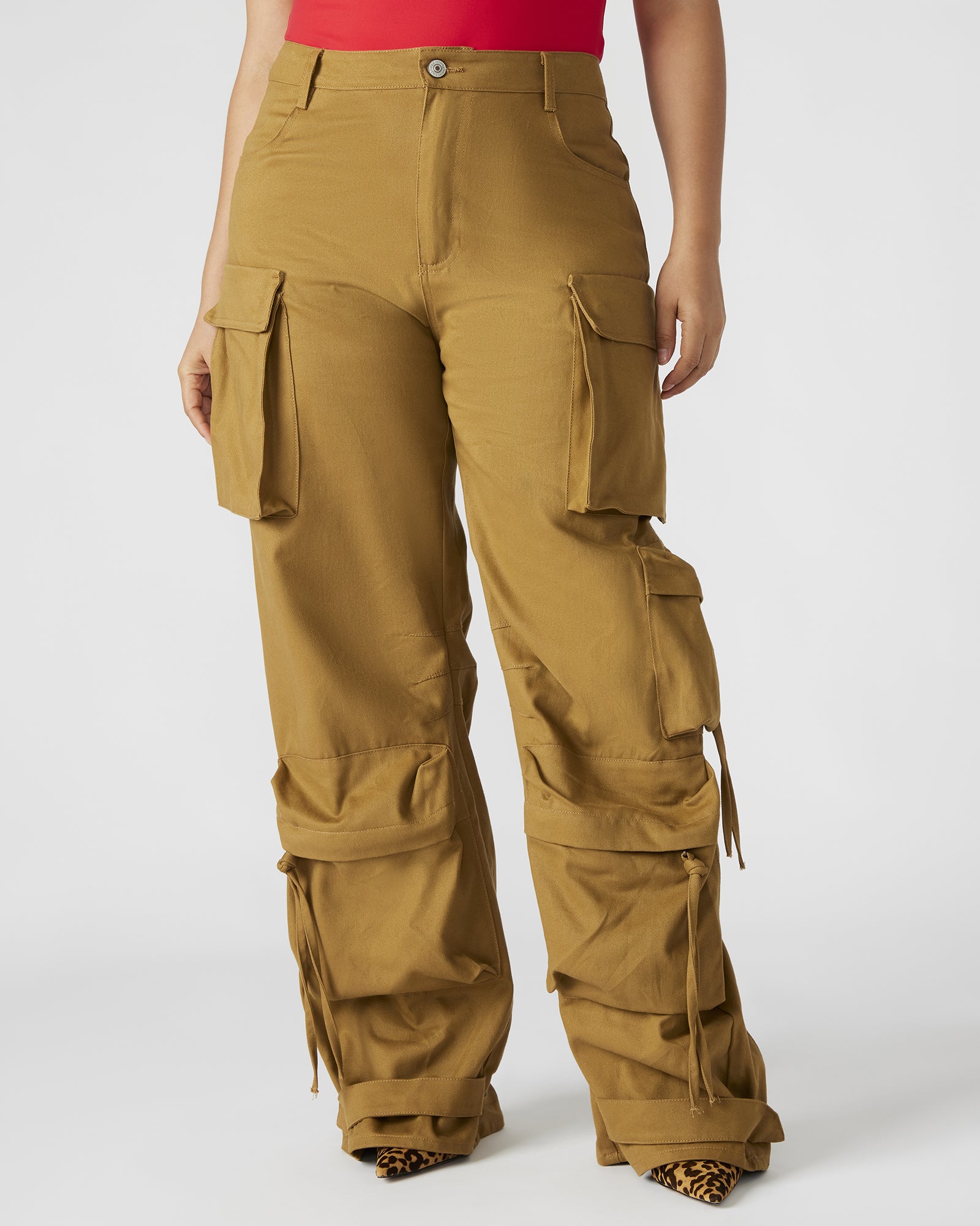 Model wearing stylish khaki wide leg pants in an outdoor setting.