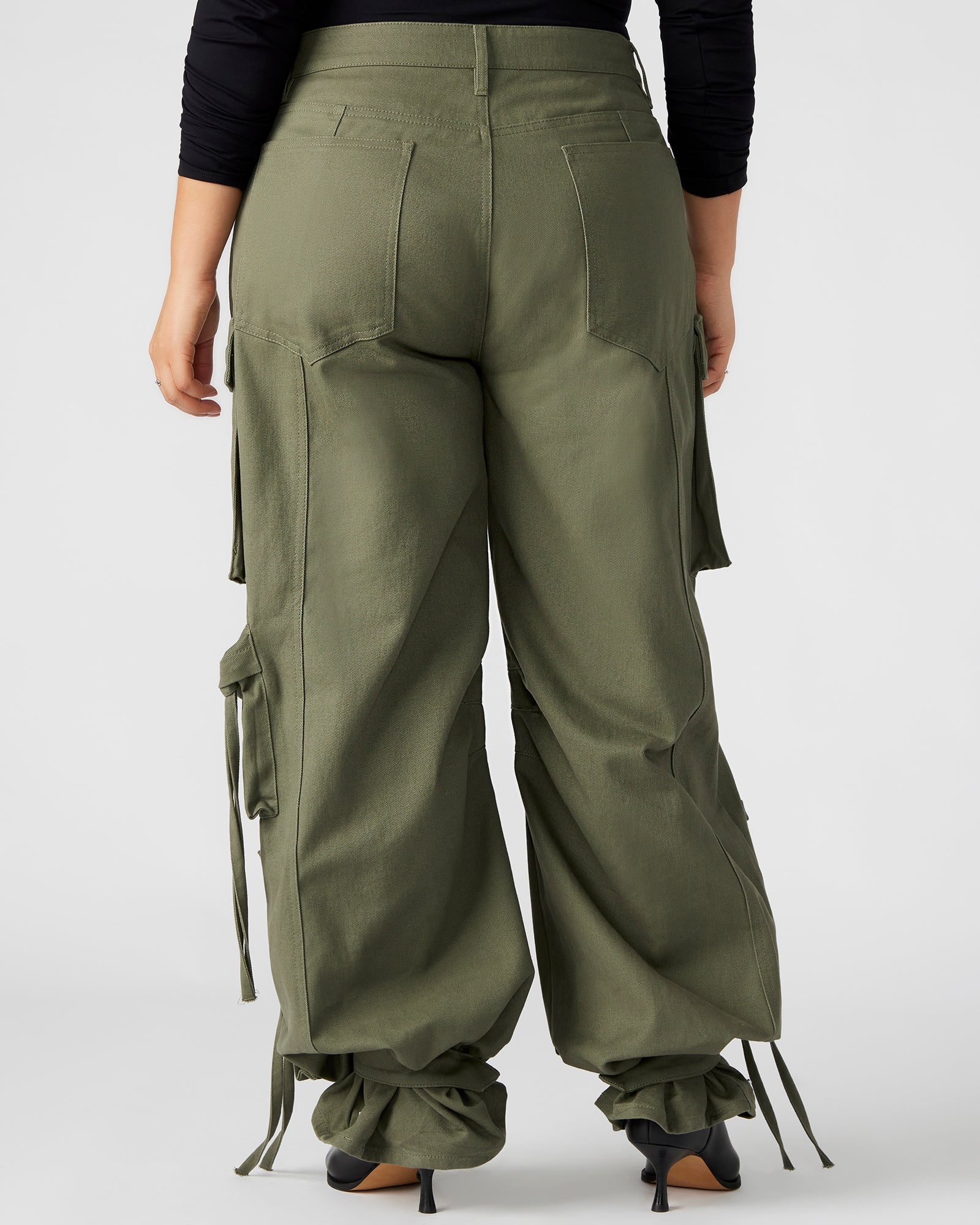 Front view of DUO olive wide leg cargo pants showing adjustable ankle straps