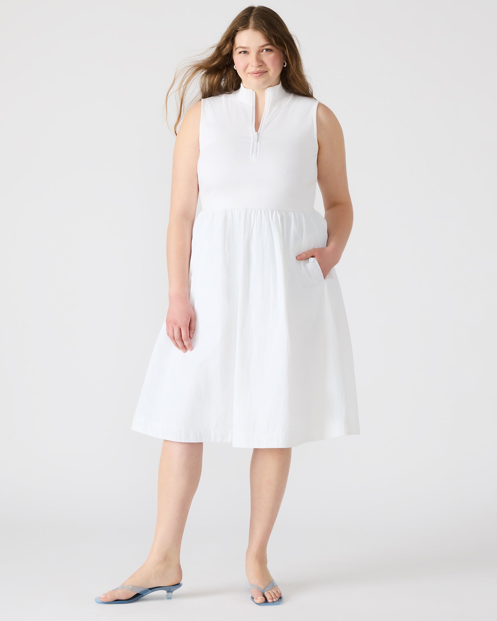 Side profile highlighting A-line skirt and functional snap pockets