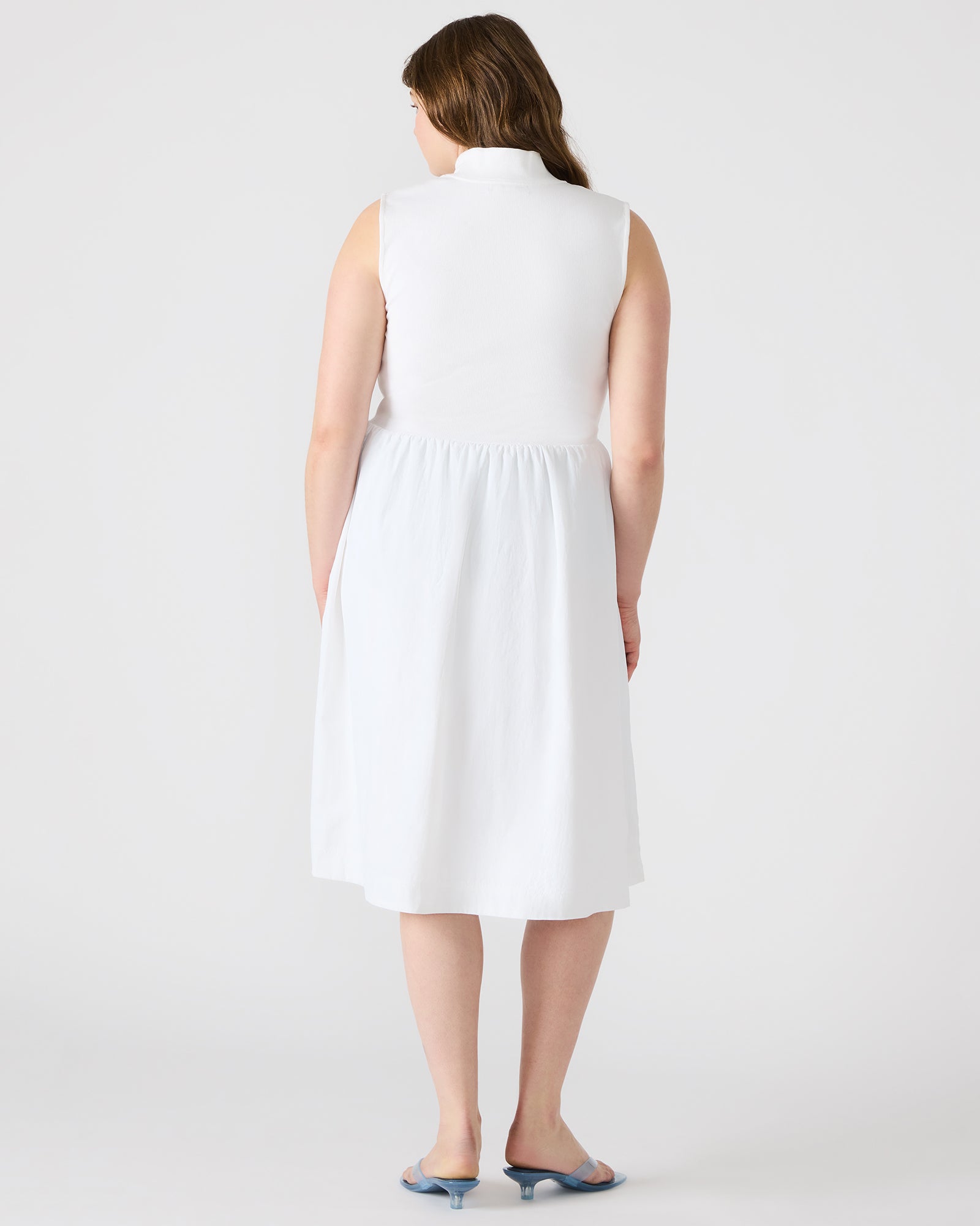 Front view of the white midi dress showcasing ribbed knit bodice and zip neckline