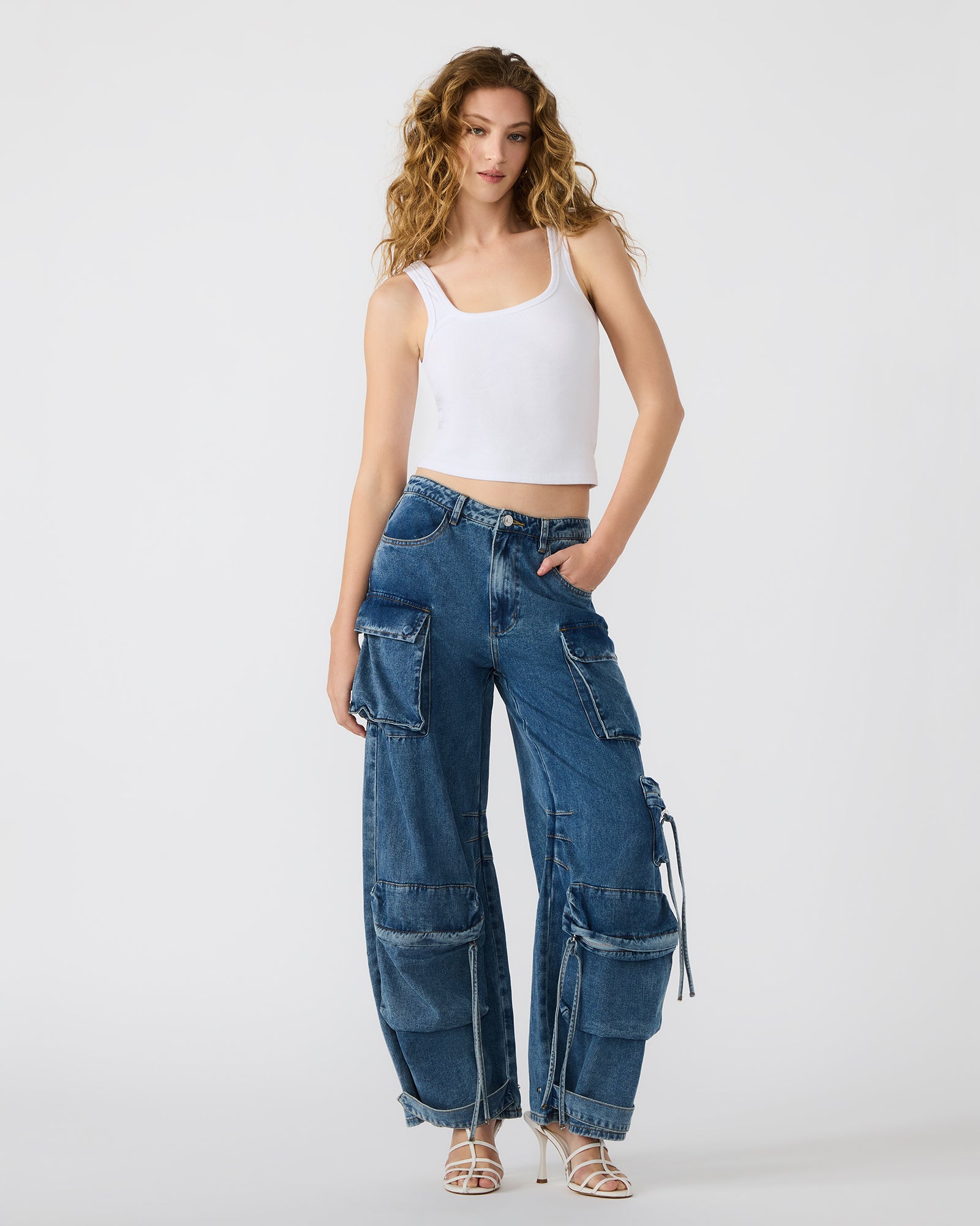 Front view of wide leg cargo pants in medium denim on a model.