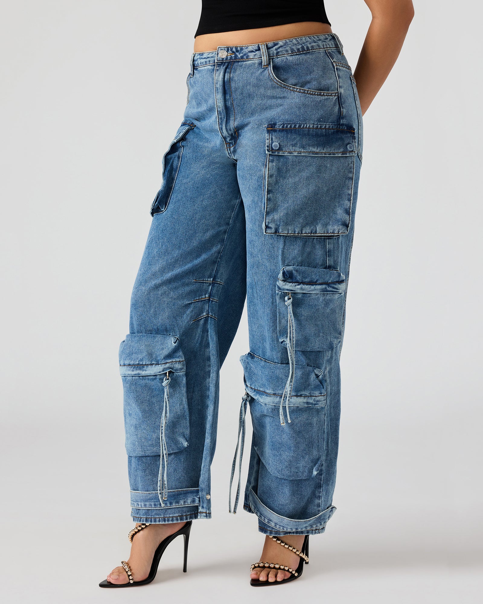 Front view of wide leg cargo pants in medium denim on a model.