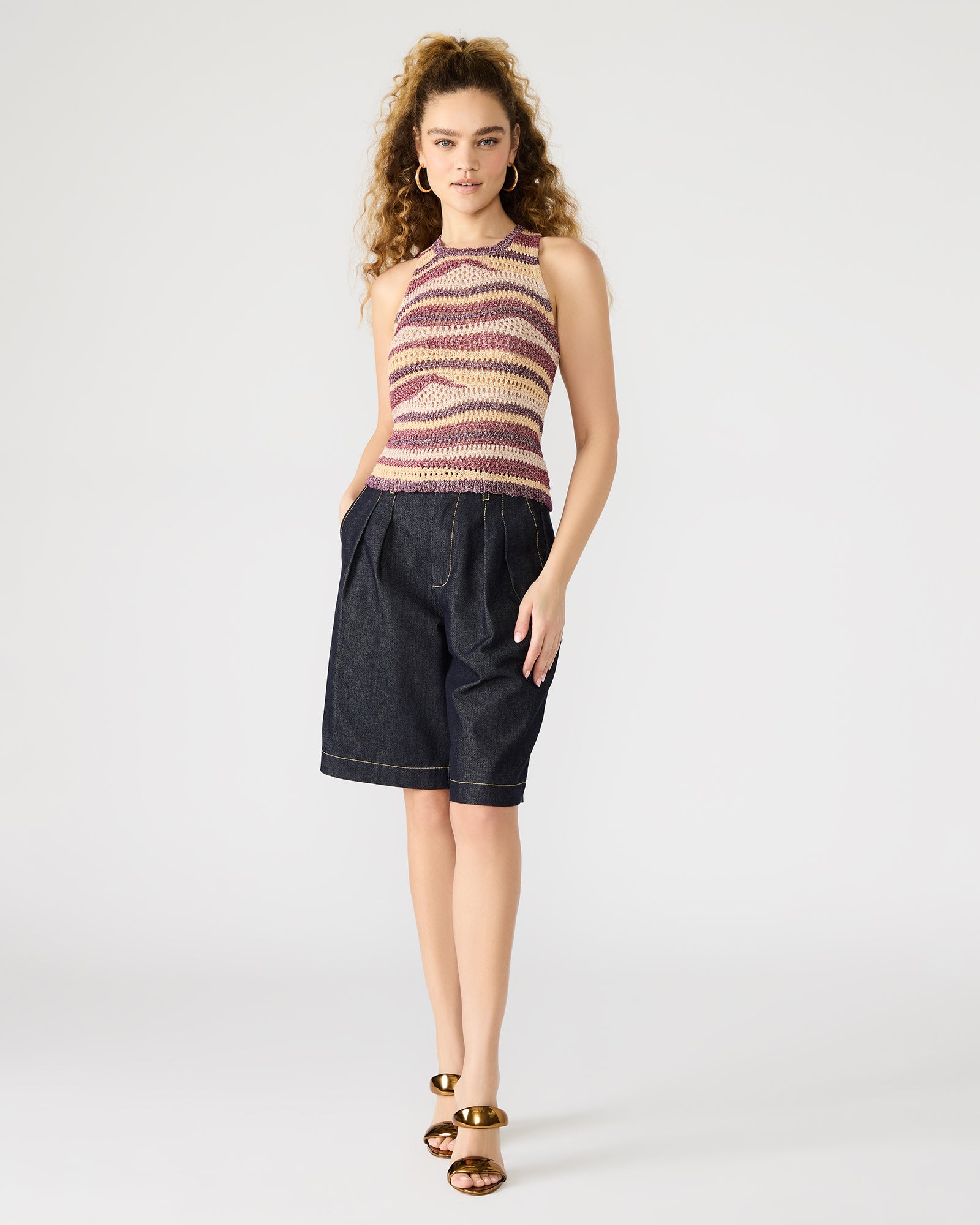 Front view of crochet tank top worn with high-rise jeans