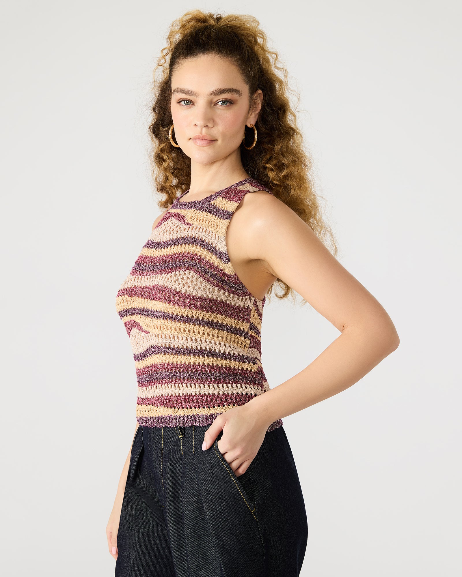 Back angle showing scalloped hem of multi-colored crochet halter top