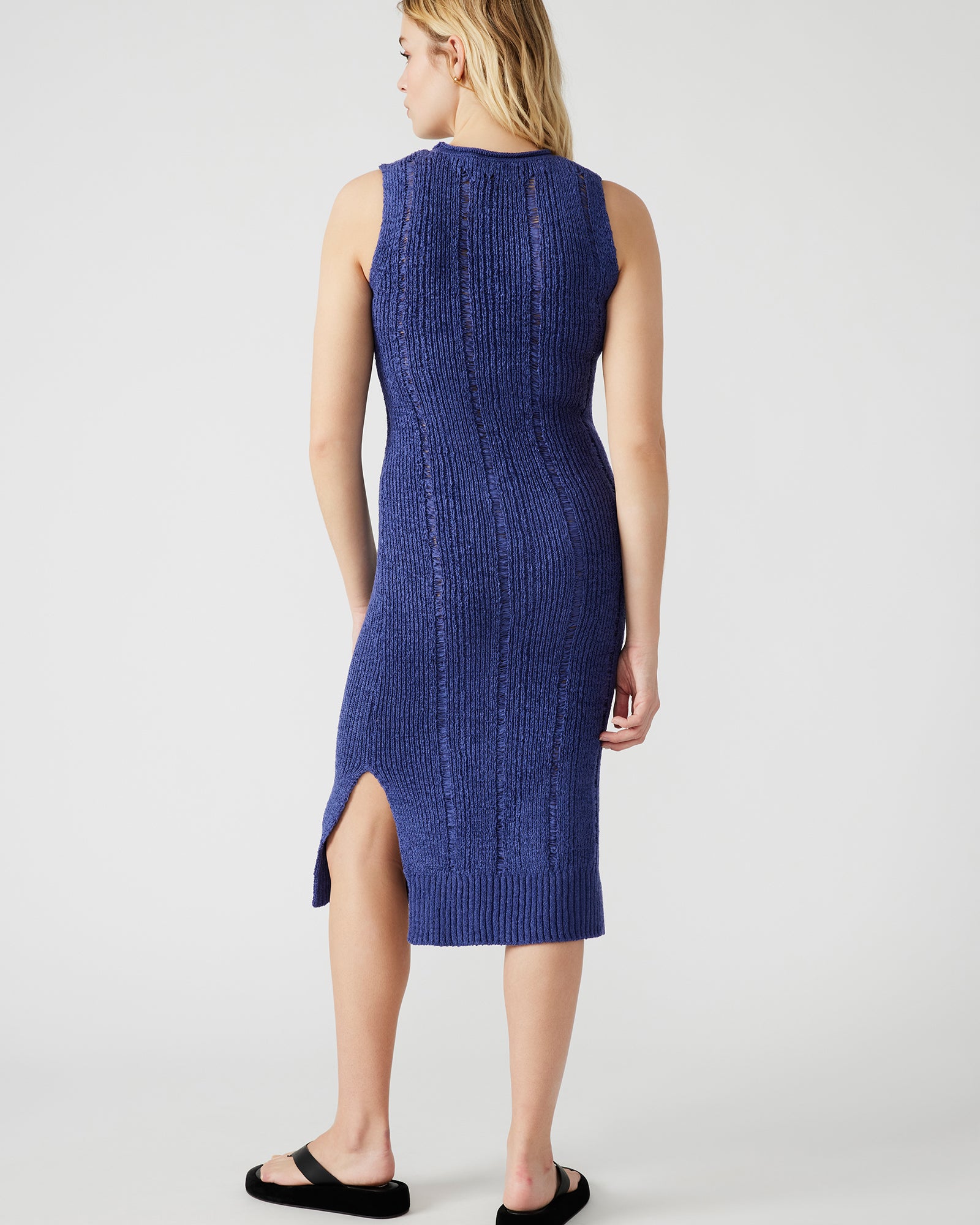 Bodycon sweater dress styled with white sneakers for casual wear
