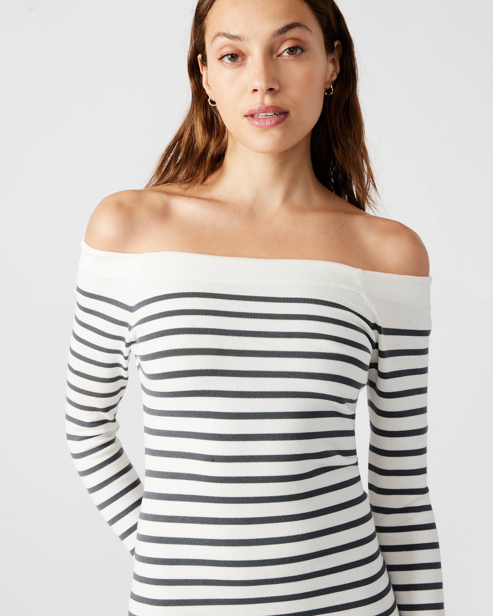 Back angle of off-the-shoulder sweater dress showing fitted silhouette and striped detailing.