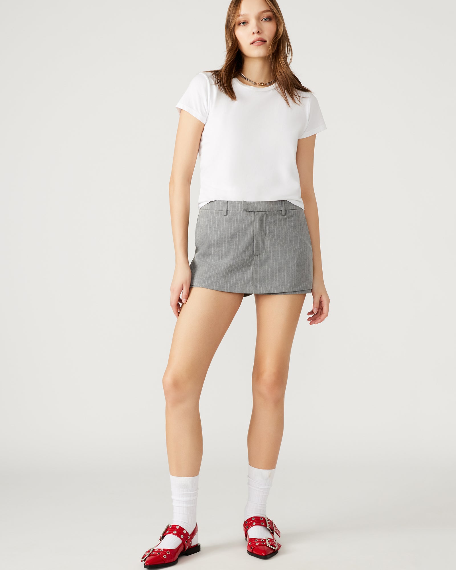 Side view of the Rodin Grey tennis skort highlighting the belt loops and mini length
