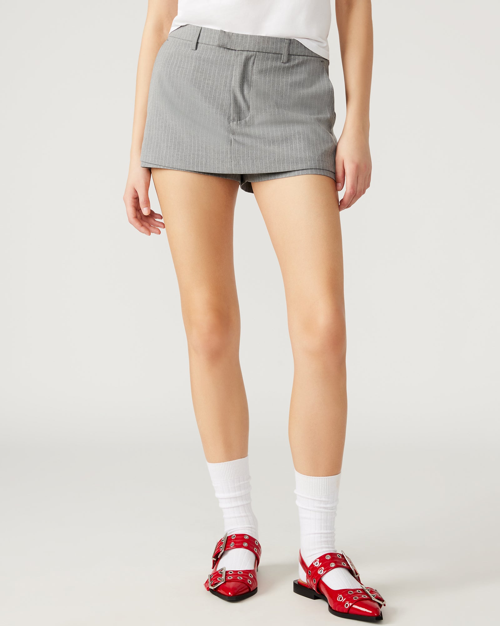 Active woman wearing the Rodin Grey athletic skort during a tennis match