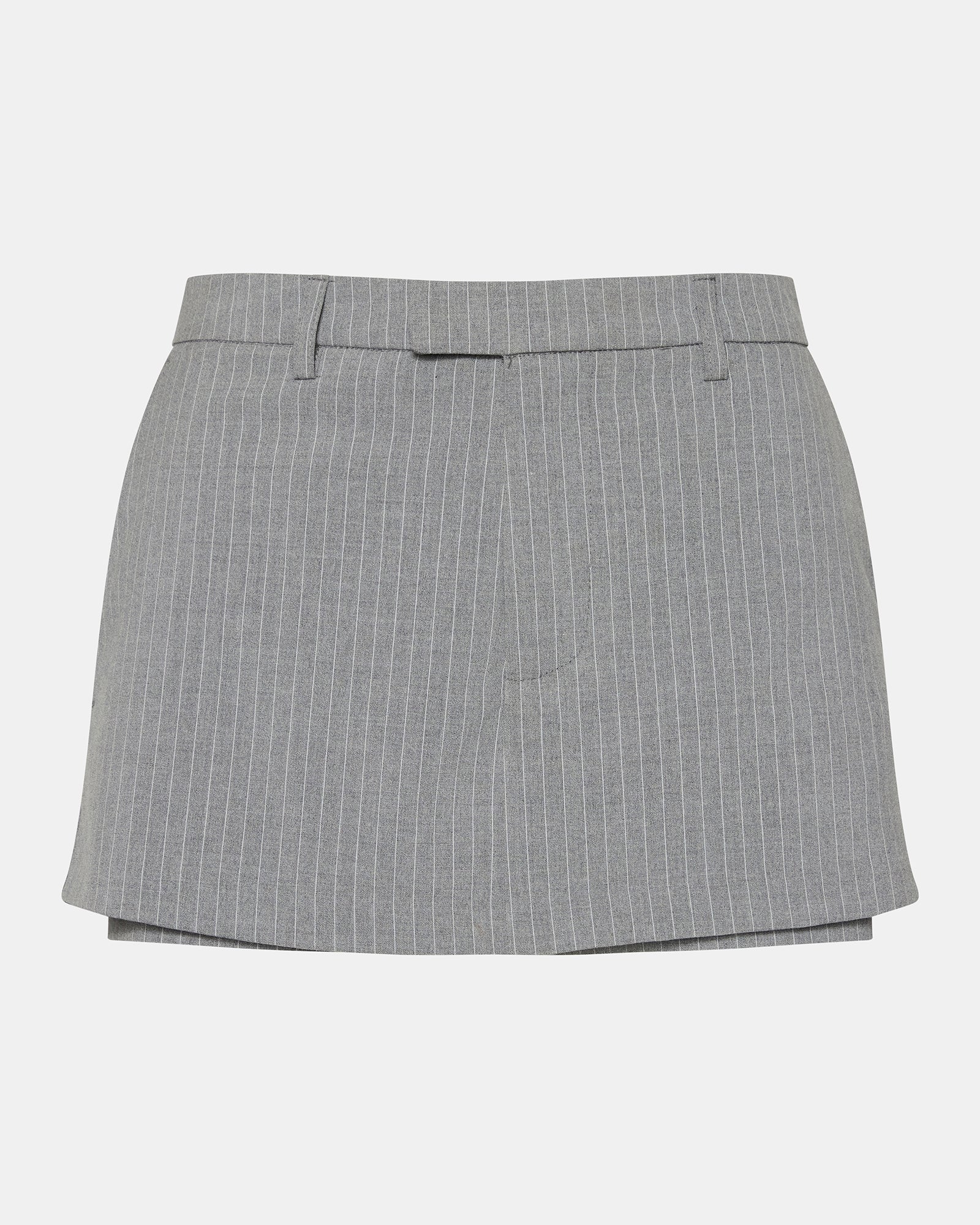 Active woman wearing the Rodin Grey athletic skort during a tennis match