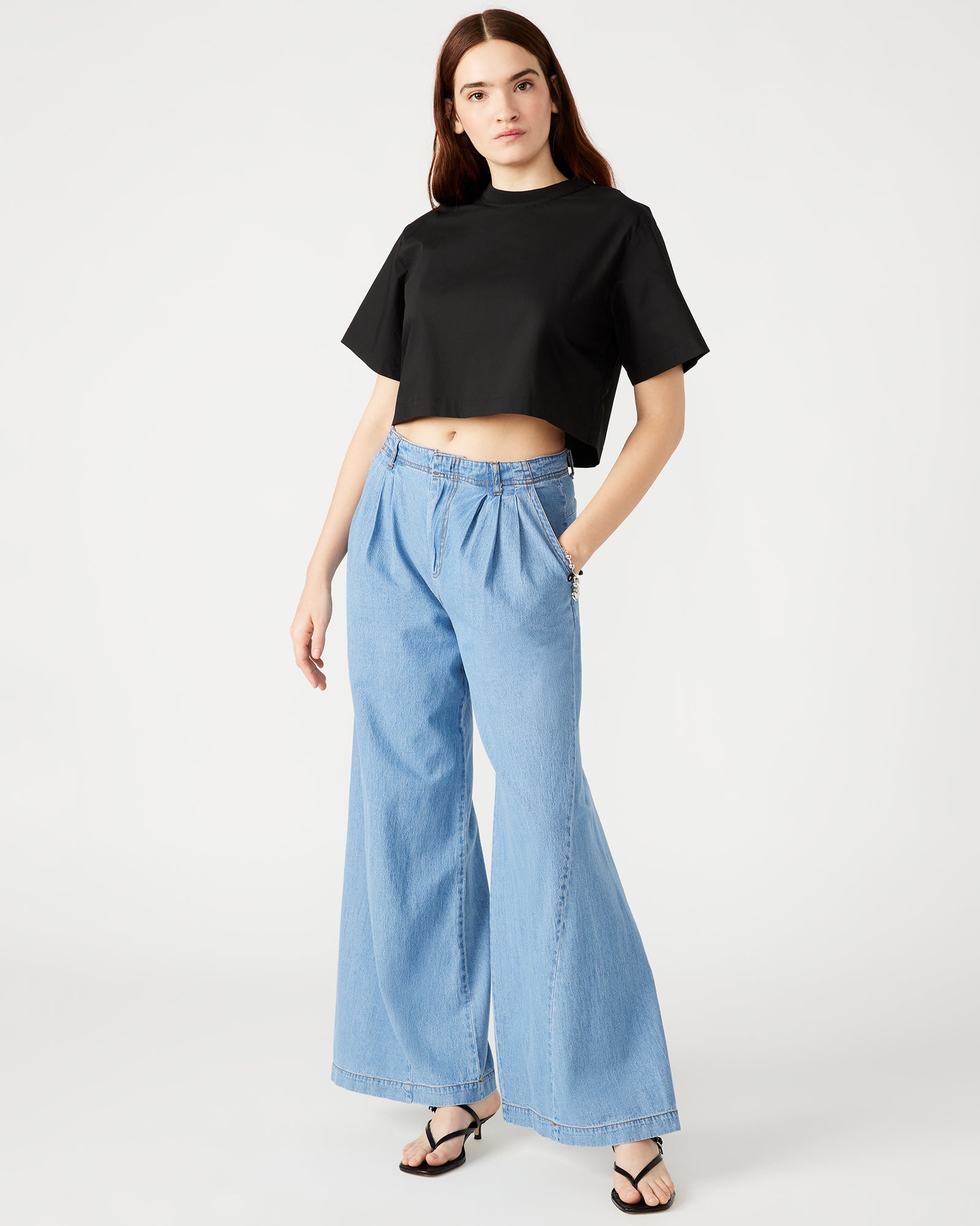Side angle of the womens black t-shirt, highlighting the relaxed fit and ribbed neck.