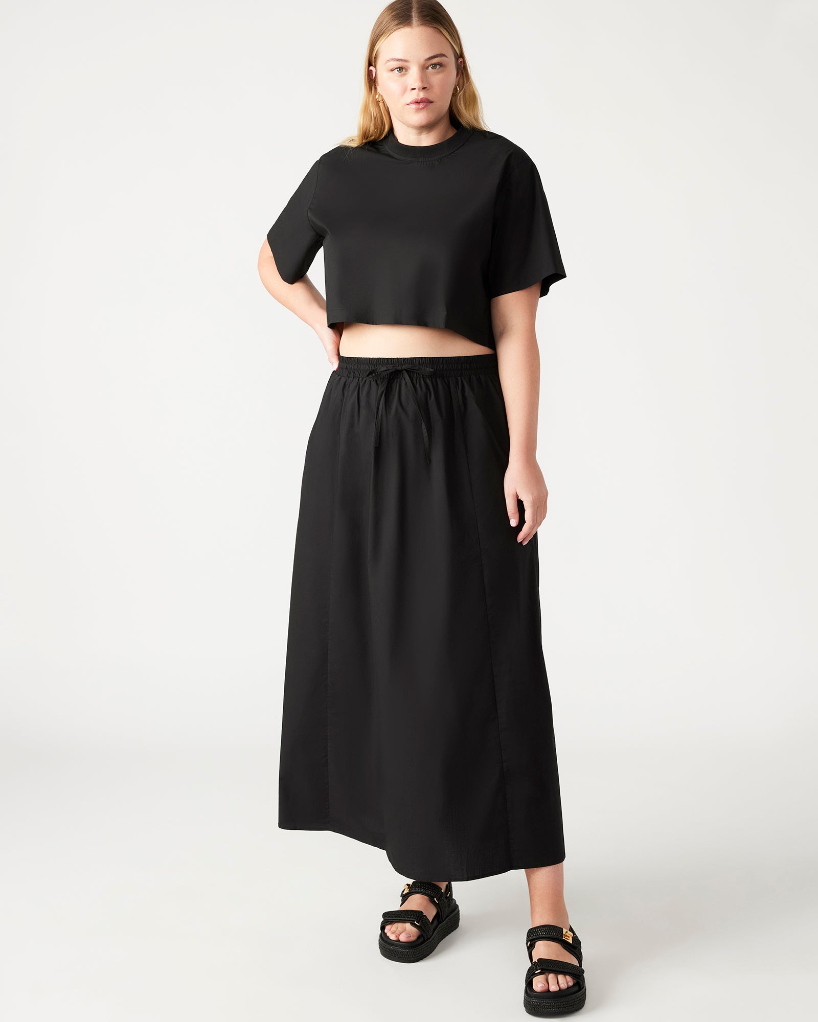 Back view of the boxy cropped t-shirt, emphasizing the full separating zipper.