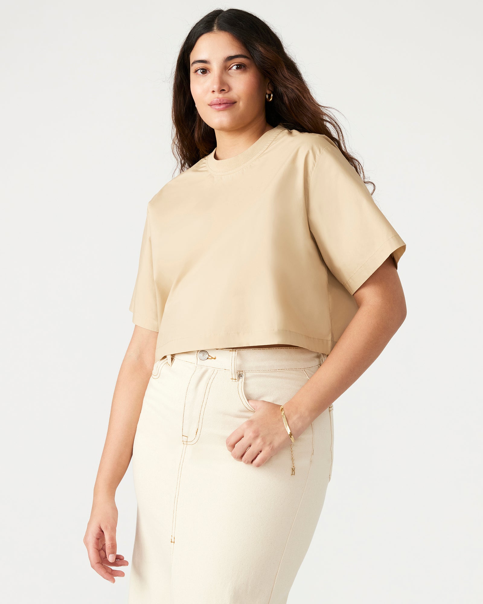 Styled outfit featuring khaki cropped t-shirt paired with relaxed denim