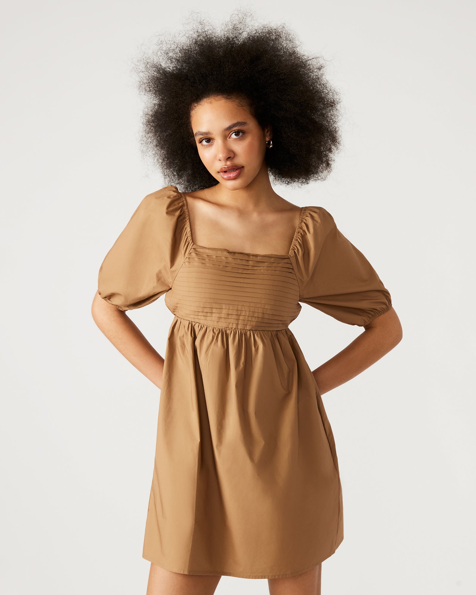 Stylish black mini dress alternative, shown alongside the beige version.