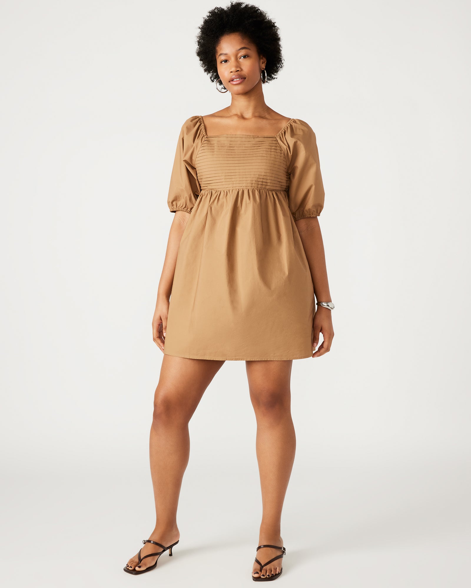 Inara beige mini dress front view, showcasing puff sleeves and square neckline.