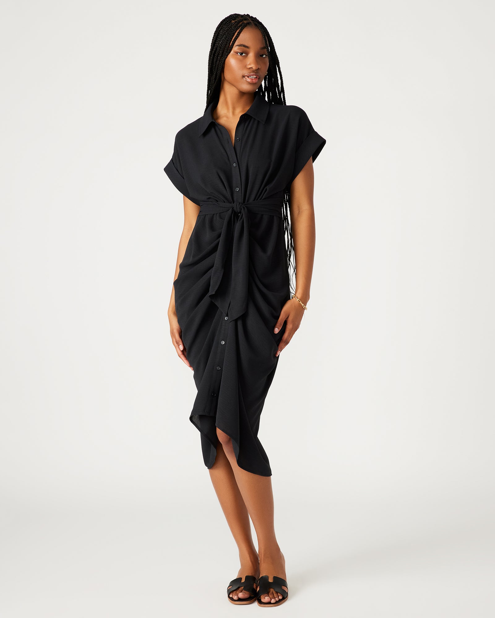 Side angle of model in tie-front dress with rolled collar