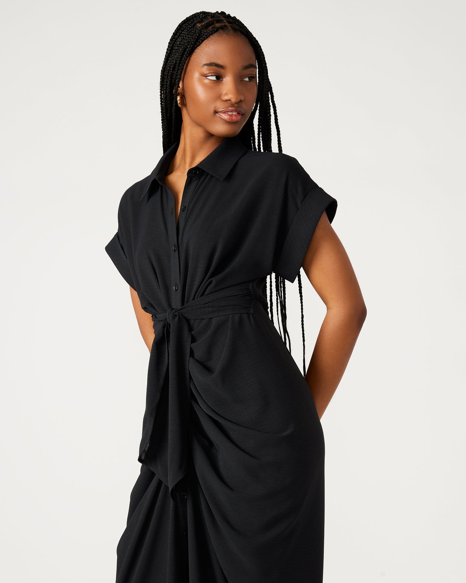 Side angle of model in tie-front dress with rolled collar