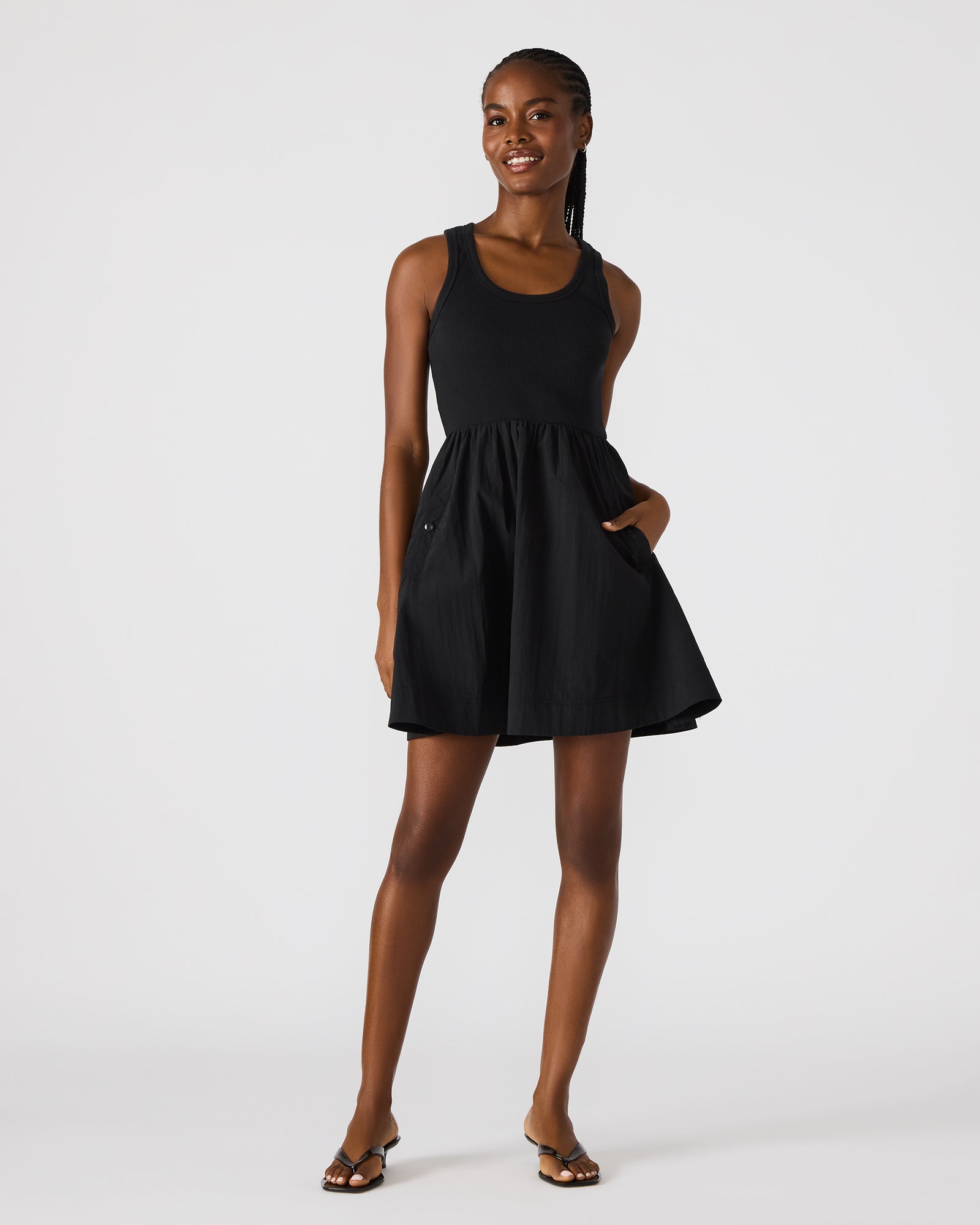 Front view of black mini dress with scoop neck and ruffle hem
