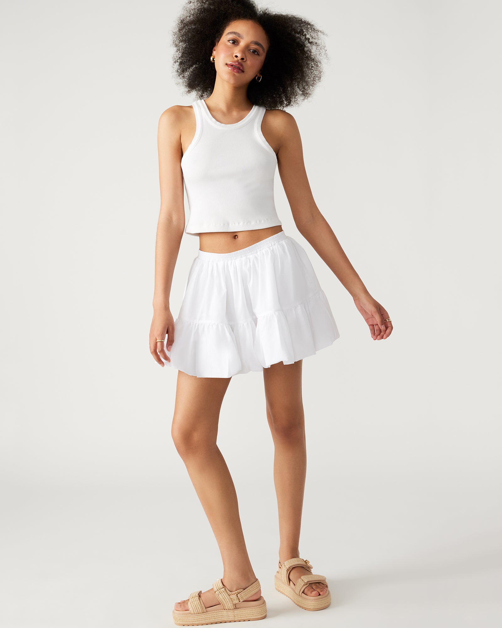 Close-up of the Aisha white mini skirt’s tiered bubble hem texture