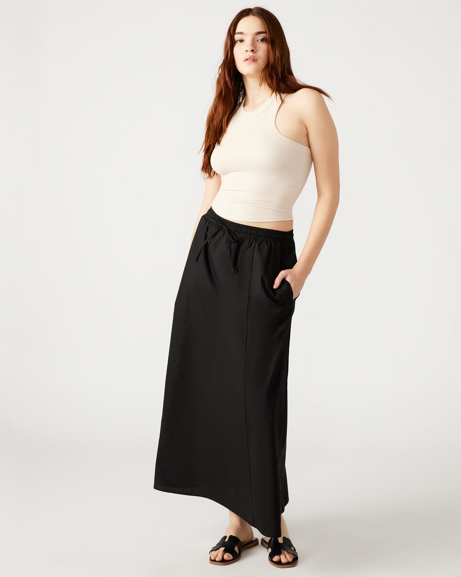 Model showcasing the flowing A-line silhouette of the black maxi skirt