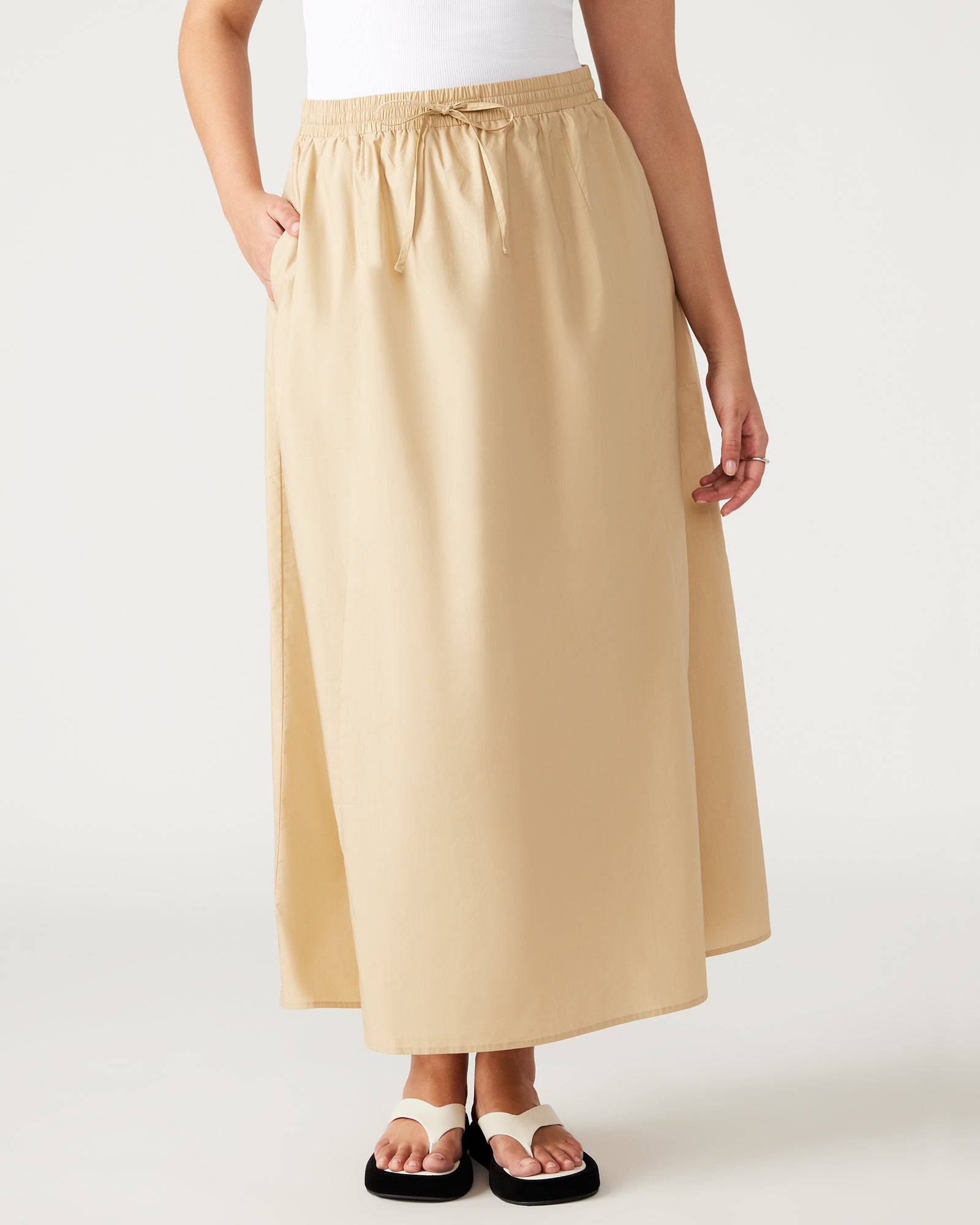 Model wearing a black maxi skirt paired with a stylish top