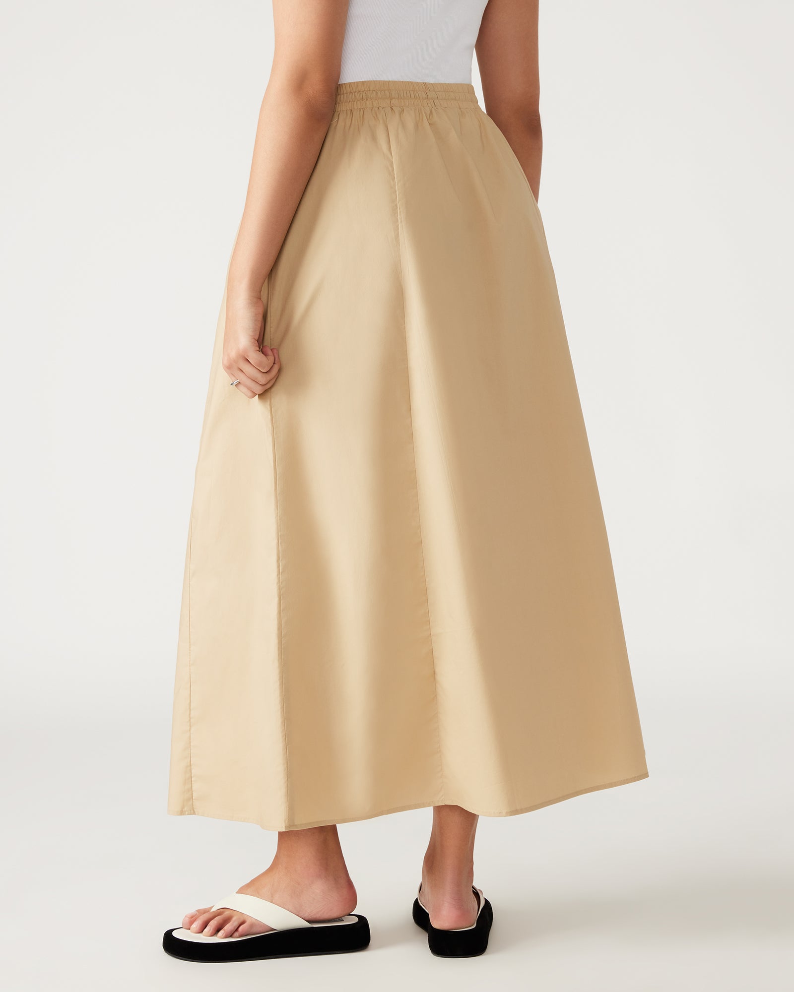 Side view of the khaki colour skirt showcasing the elastic waistband