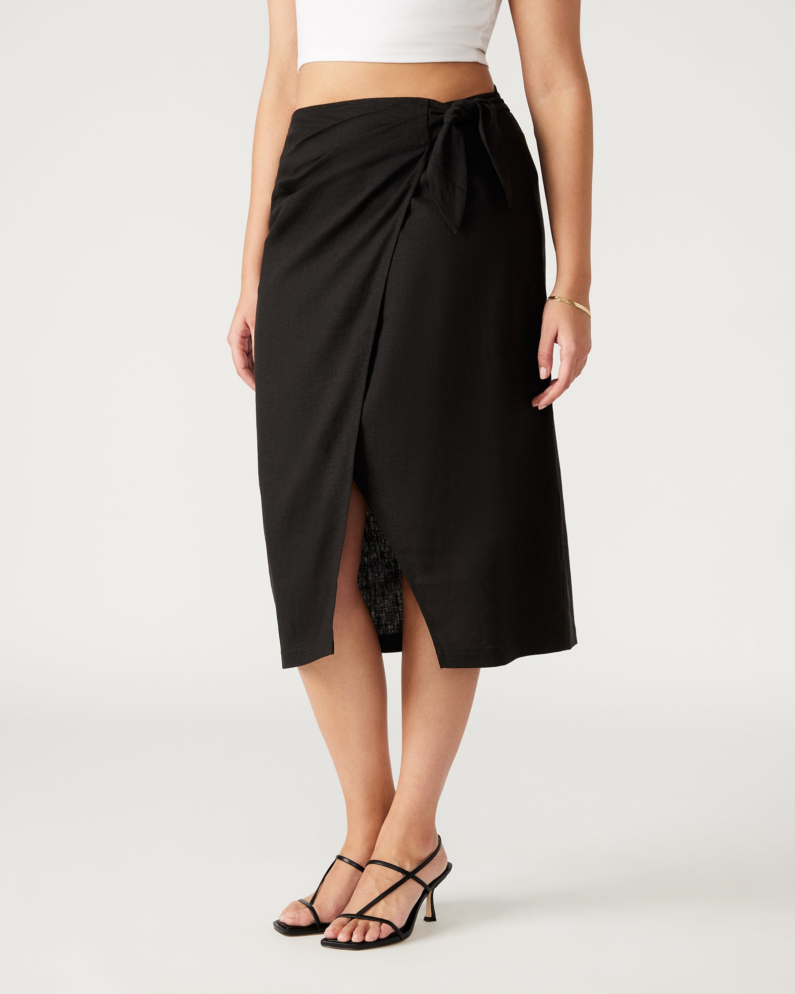 Front view of Isadora black linen maxi skirt styled with a casual top.