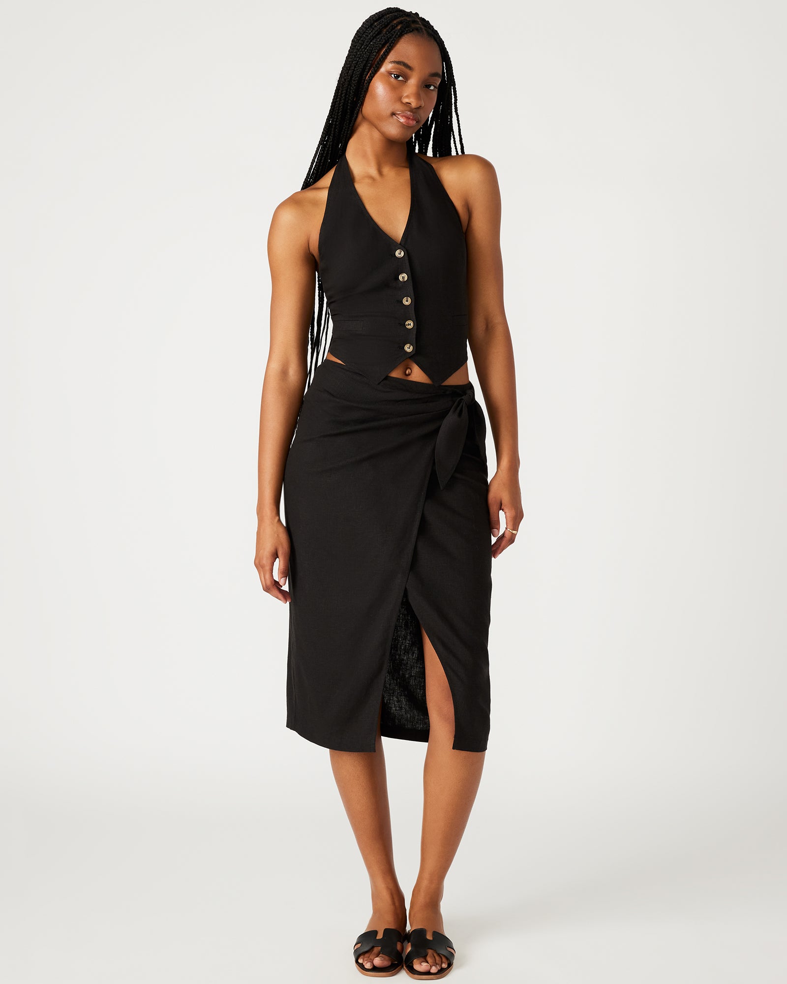 Front view of Isadora black linen maxi skirt styled with a casual top.