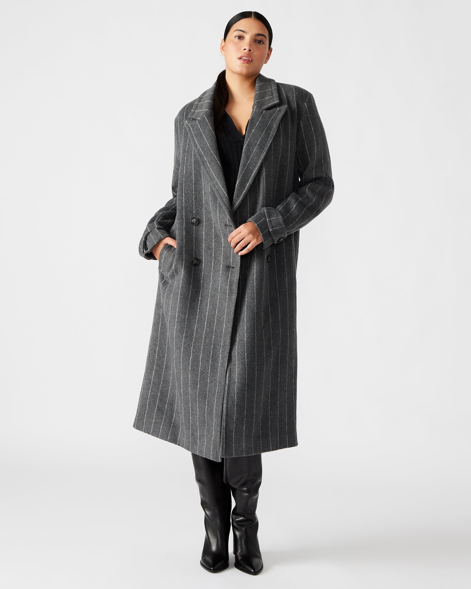 Front view of a pinstripe double-breasted trench coat on a model