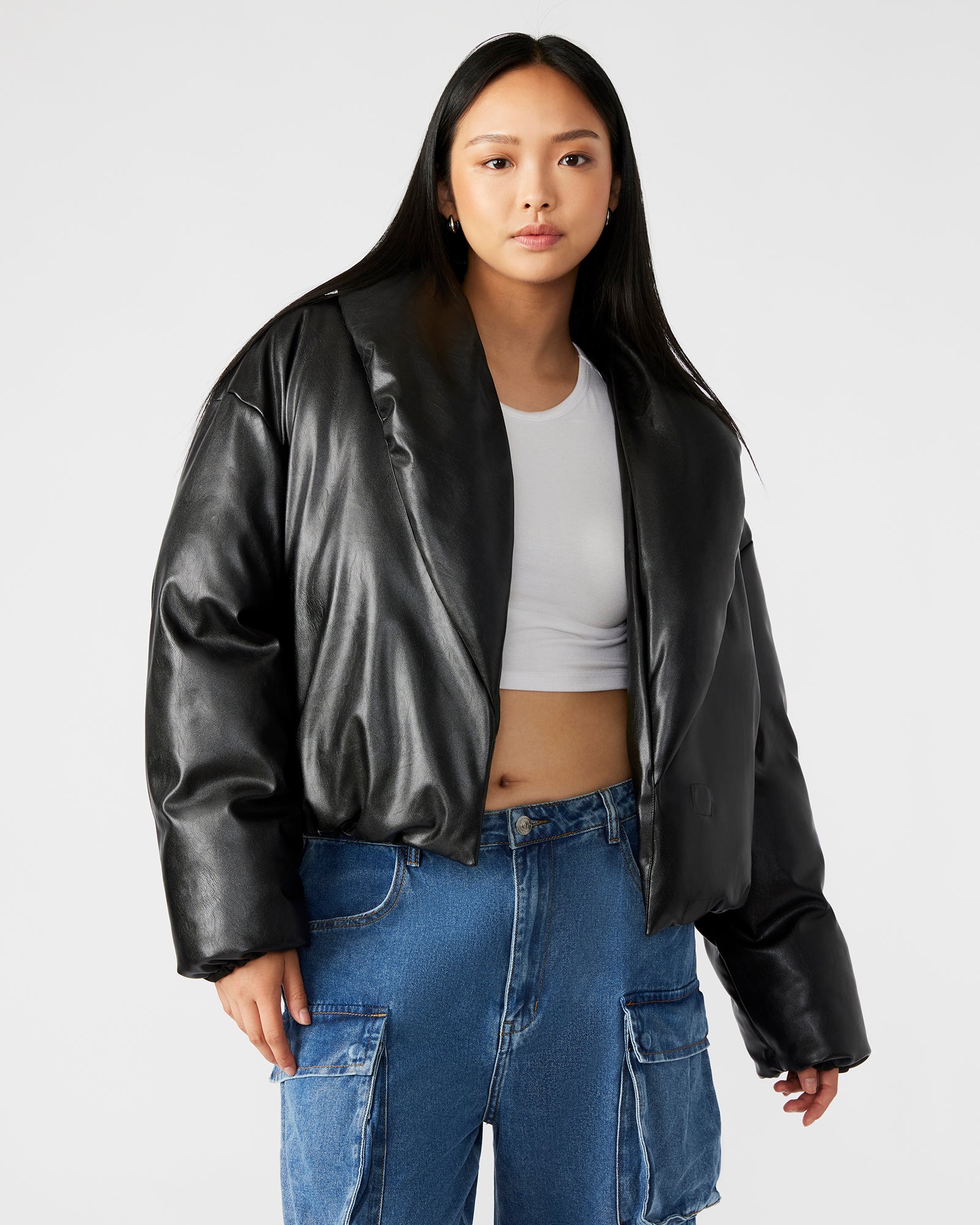Side view of the womens puffer jacket highlighting the magnetic closure and pockets.