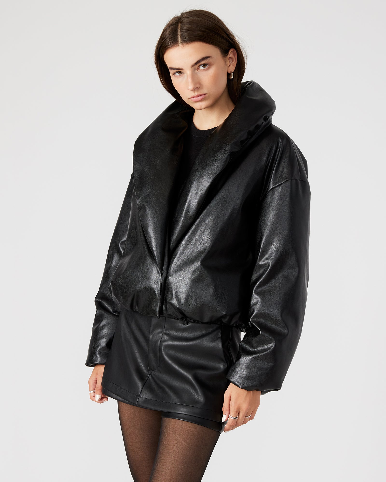 Model wearing the long puffer jacket in a winter setting, demonstrating its stylish appeal.