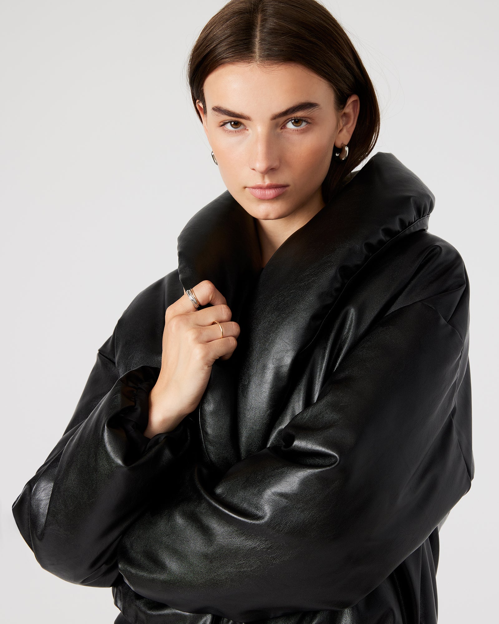 Side view of the womens puffer jacket highlighting the magnetic closure and pockets.