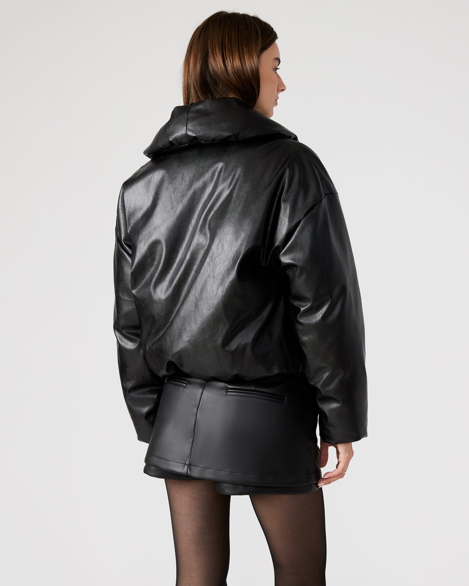 Front view of the black vegan leather puffer jacket showcasing the shawl collar.