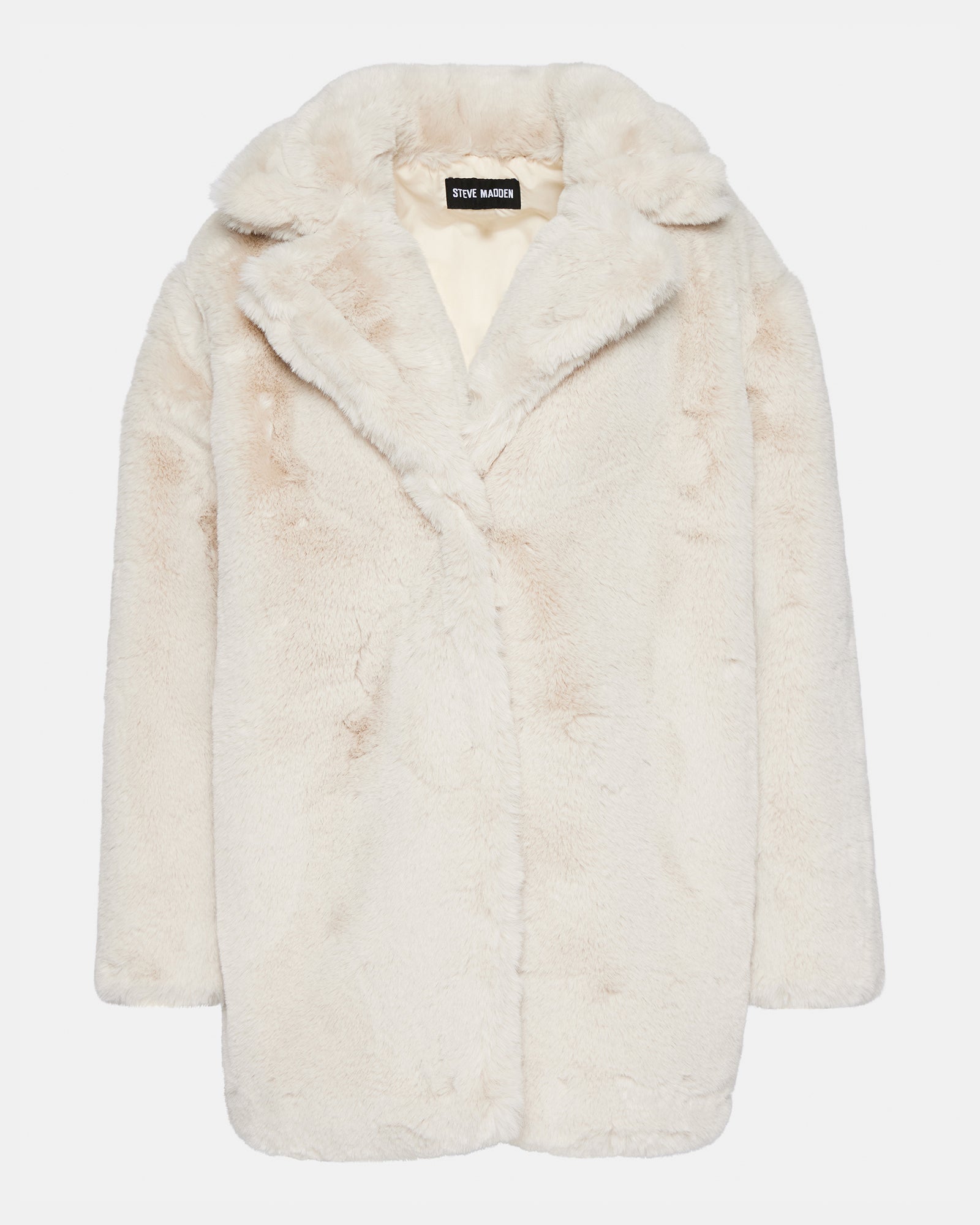 Model wearing a chic beige faux fur coat in a winter landscape.