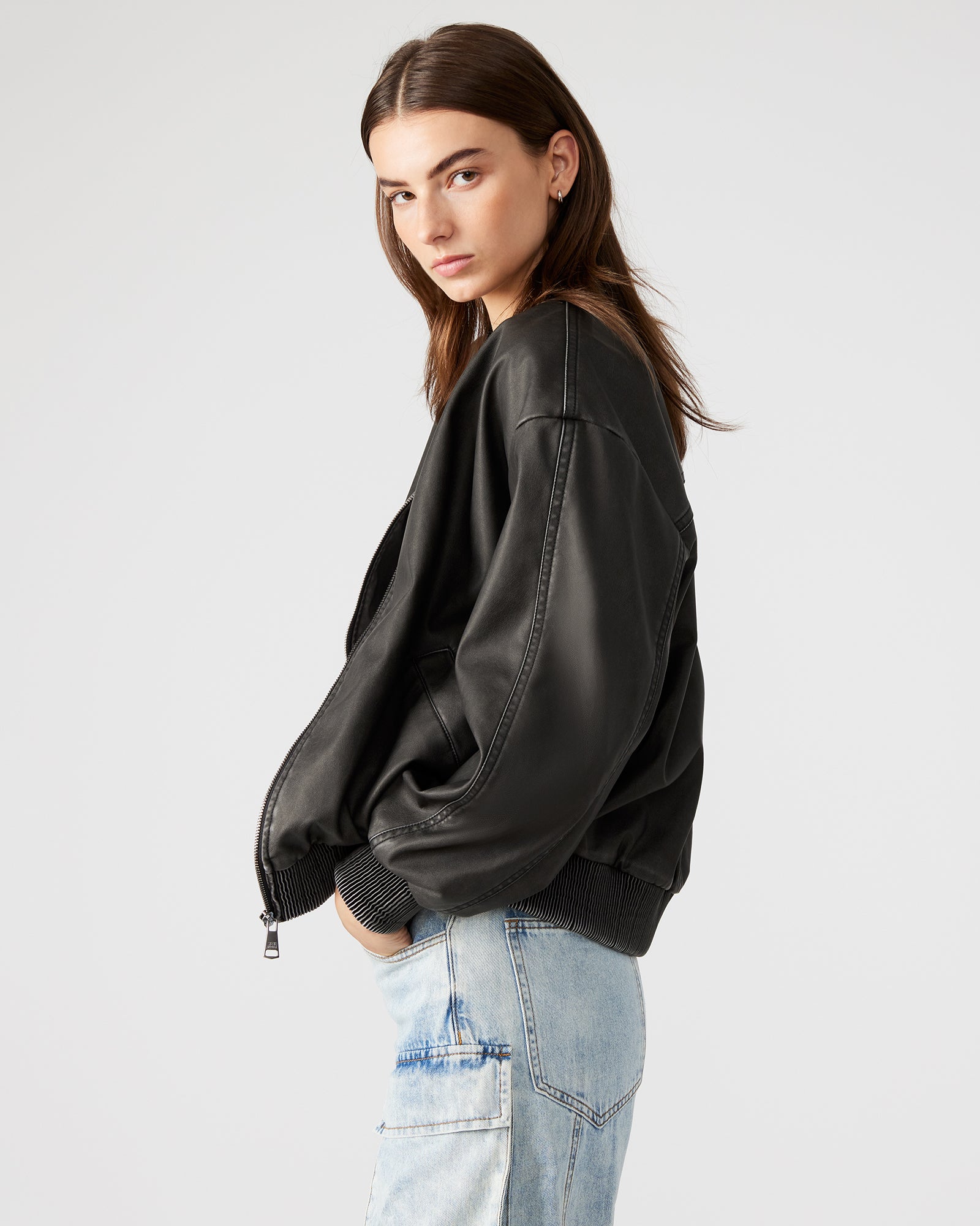 Back view highlighting relaxed cut of black bomber jacket for daily use