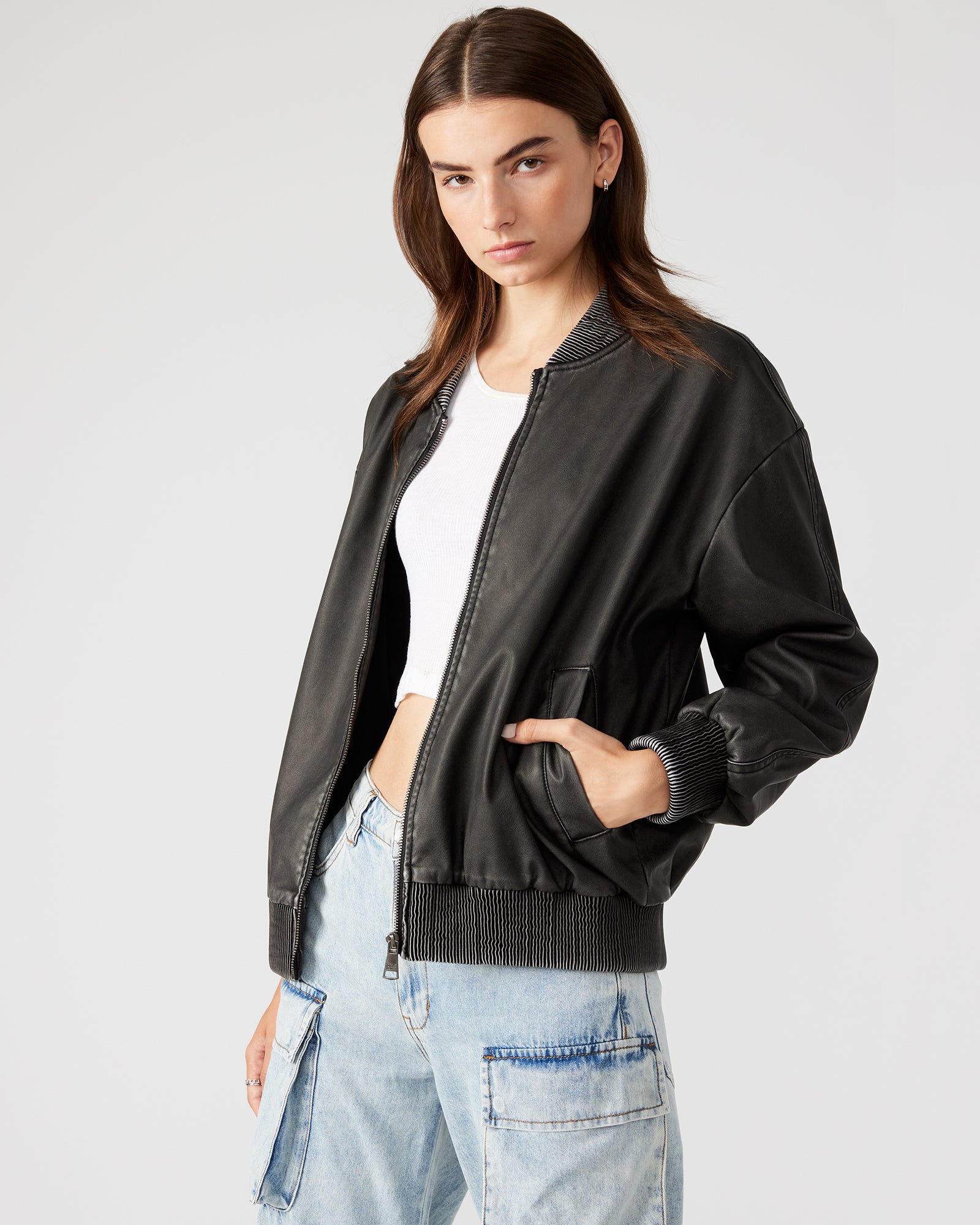 Side profile showing bomber jacket womens fit and length with street styling