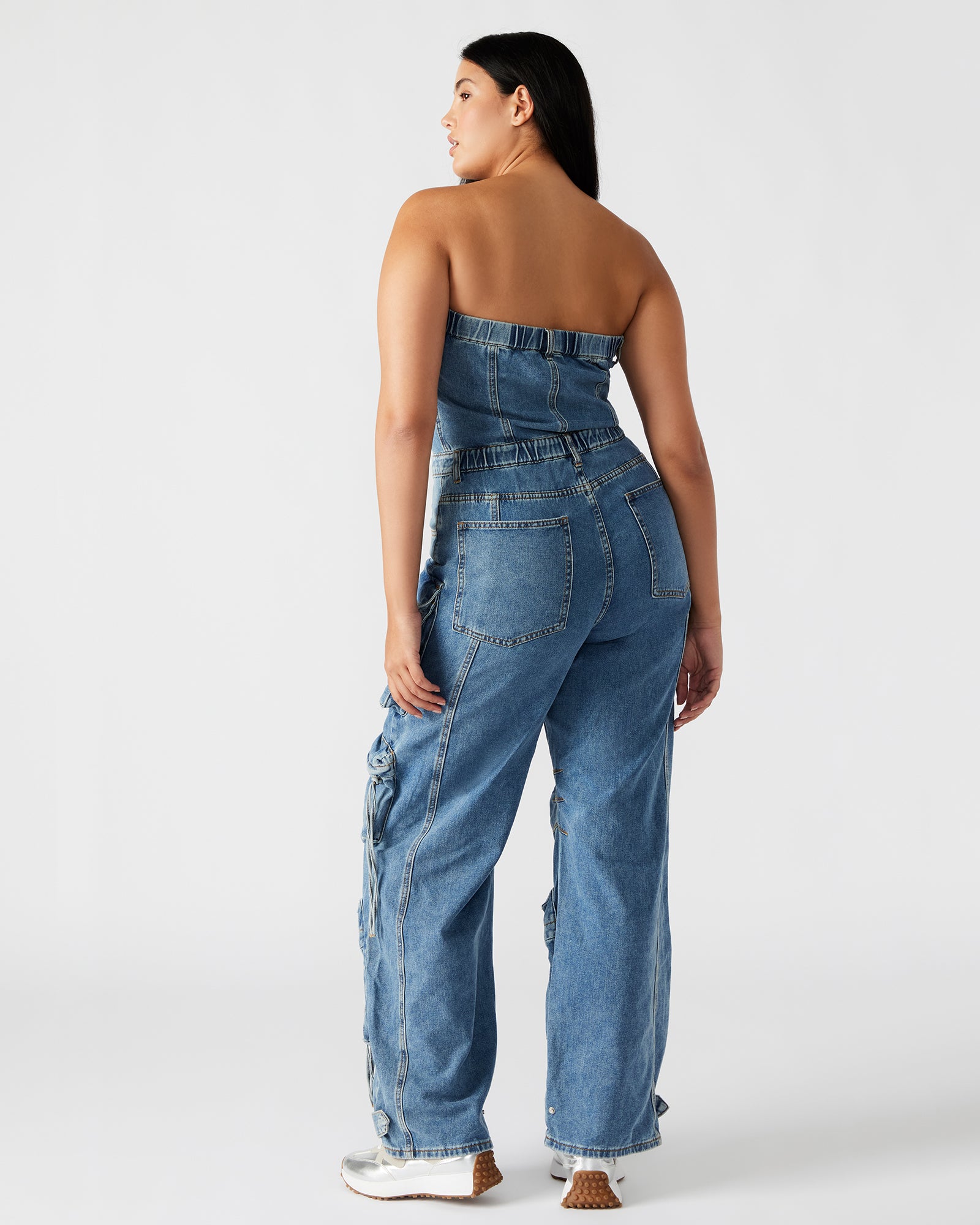 Front view of the white jumpsuit highlighting its structured fit and pockets