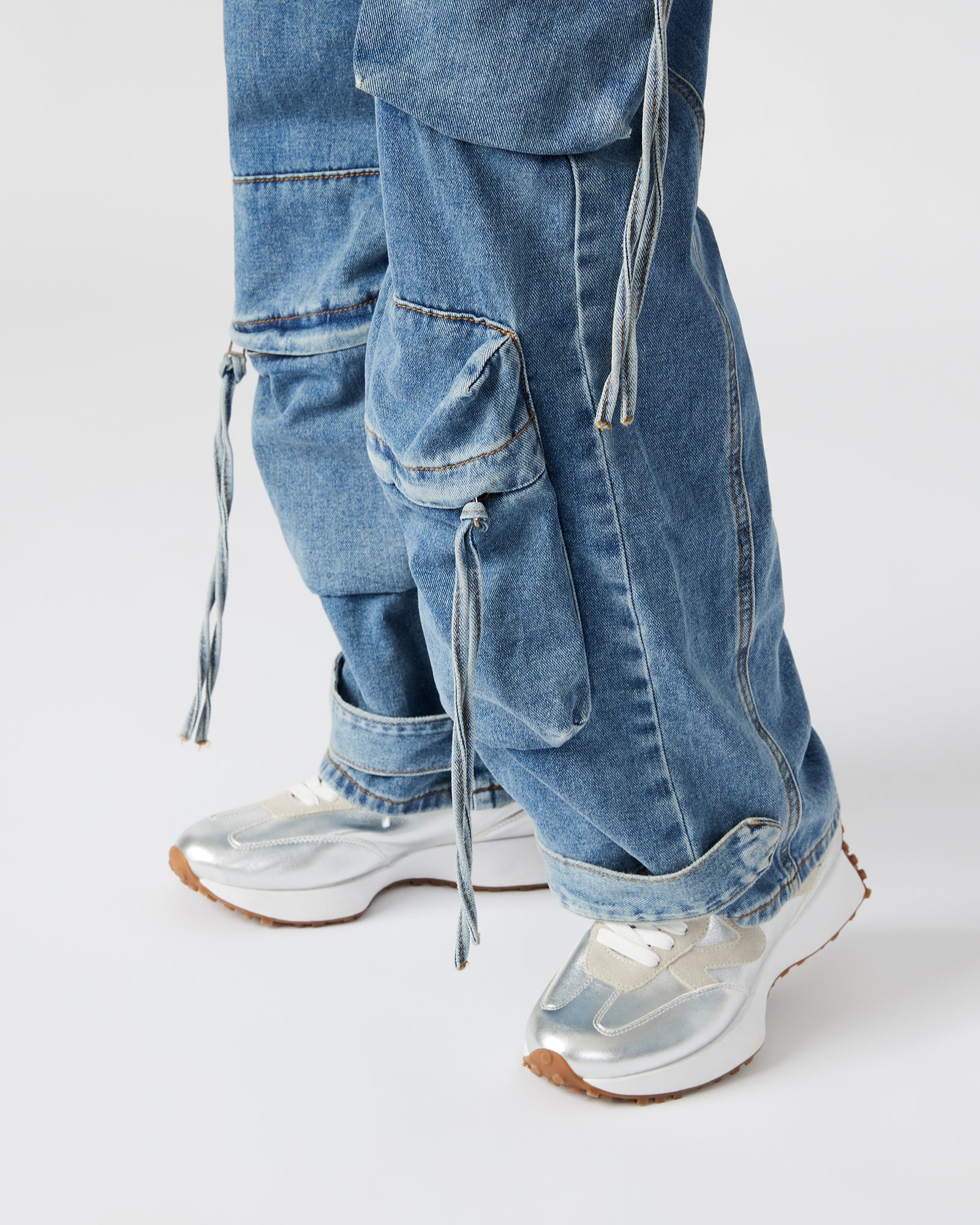 Front view of the white jumpsuit highlighting its structured fit and pockets