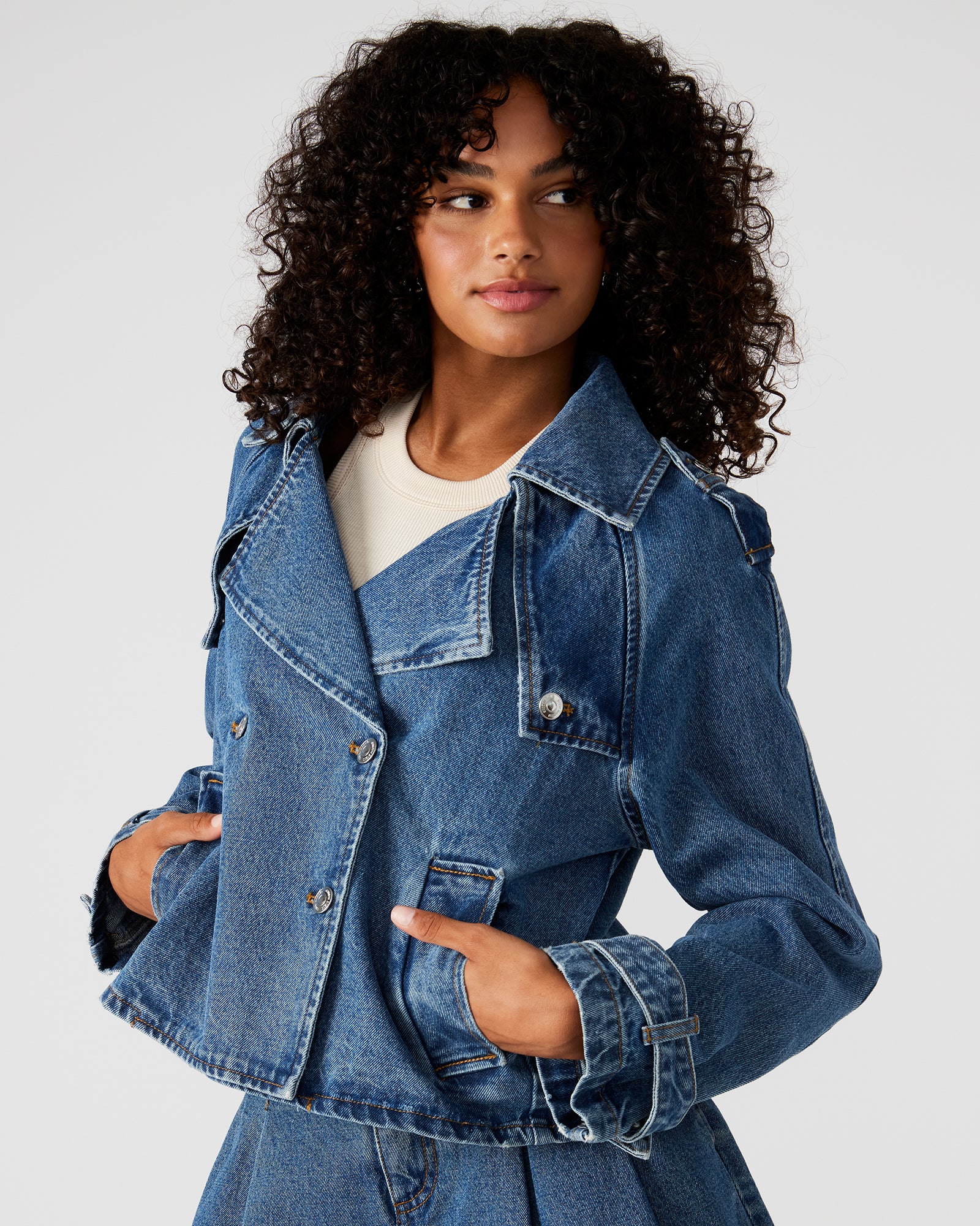 Front view of the SIRUS cropped denim jacket on a model, highlighting its double-breasted design.