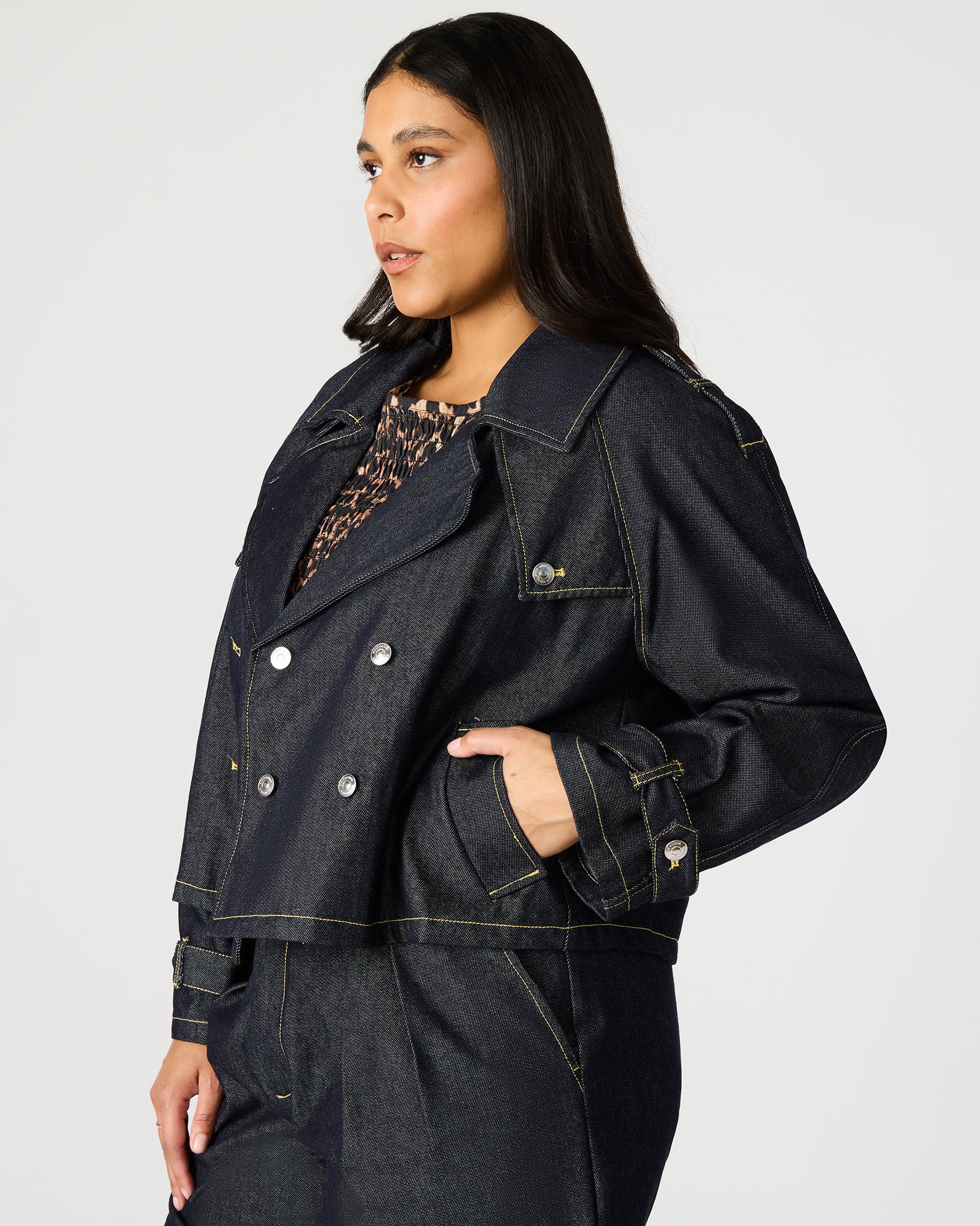 Side view of mens denim jacket highlighting functional pockets.