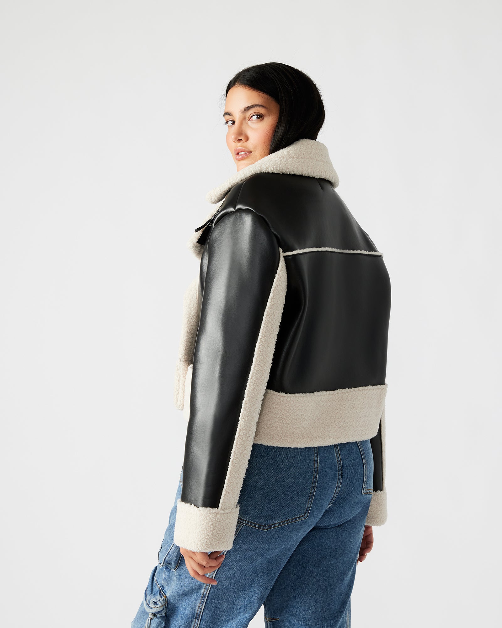 Close-up of the double-breasted design of the oversized jean jacket.